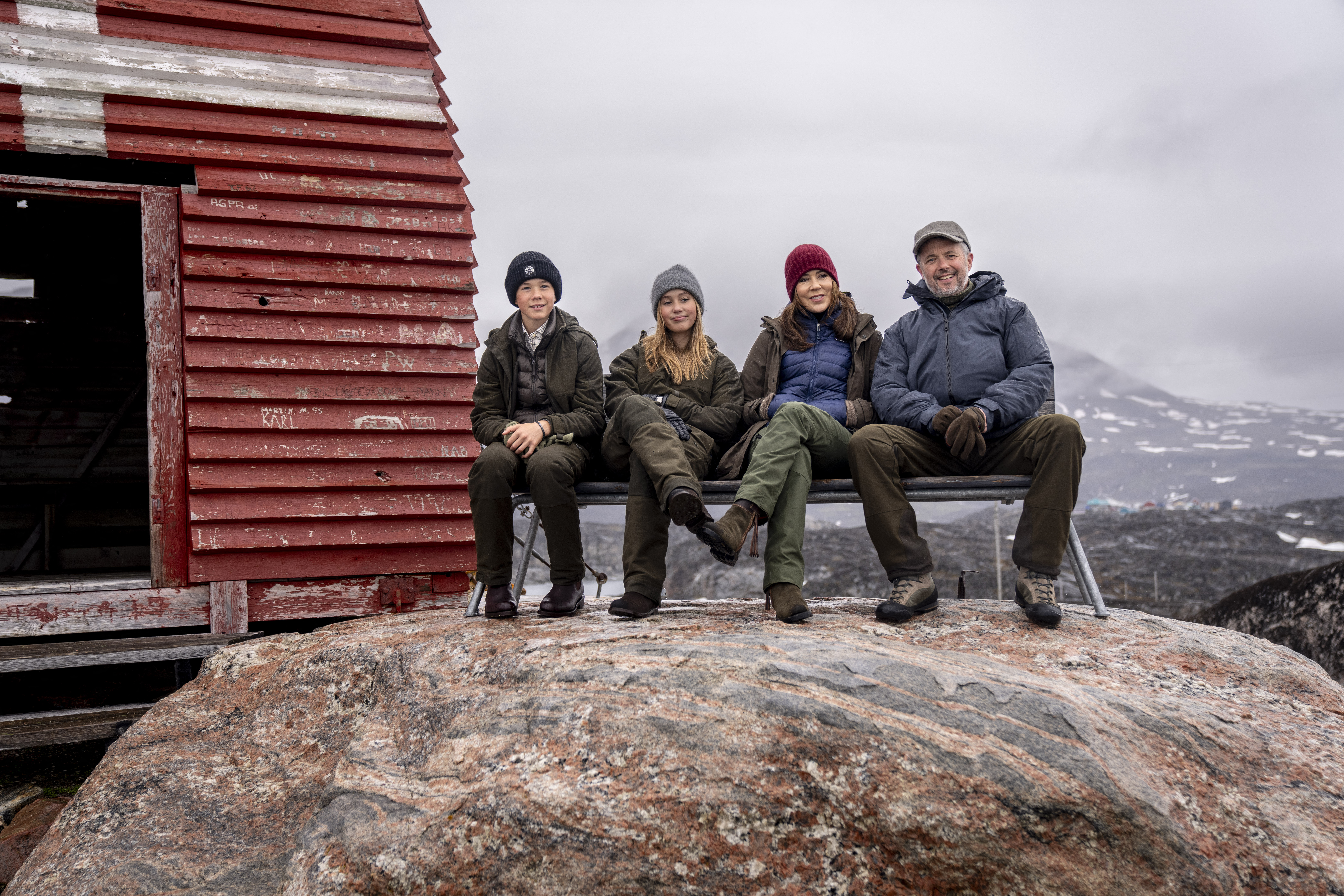 Denmarks's King Frederick X, Queen Mary, Princess Josephine and Prince Vincent pose on a bench during a visit in Qeqertarsuaq in Greenland, on June 30, 2024.