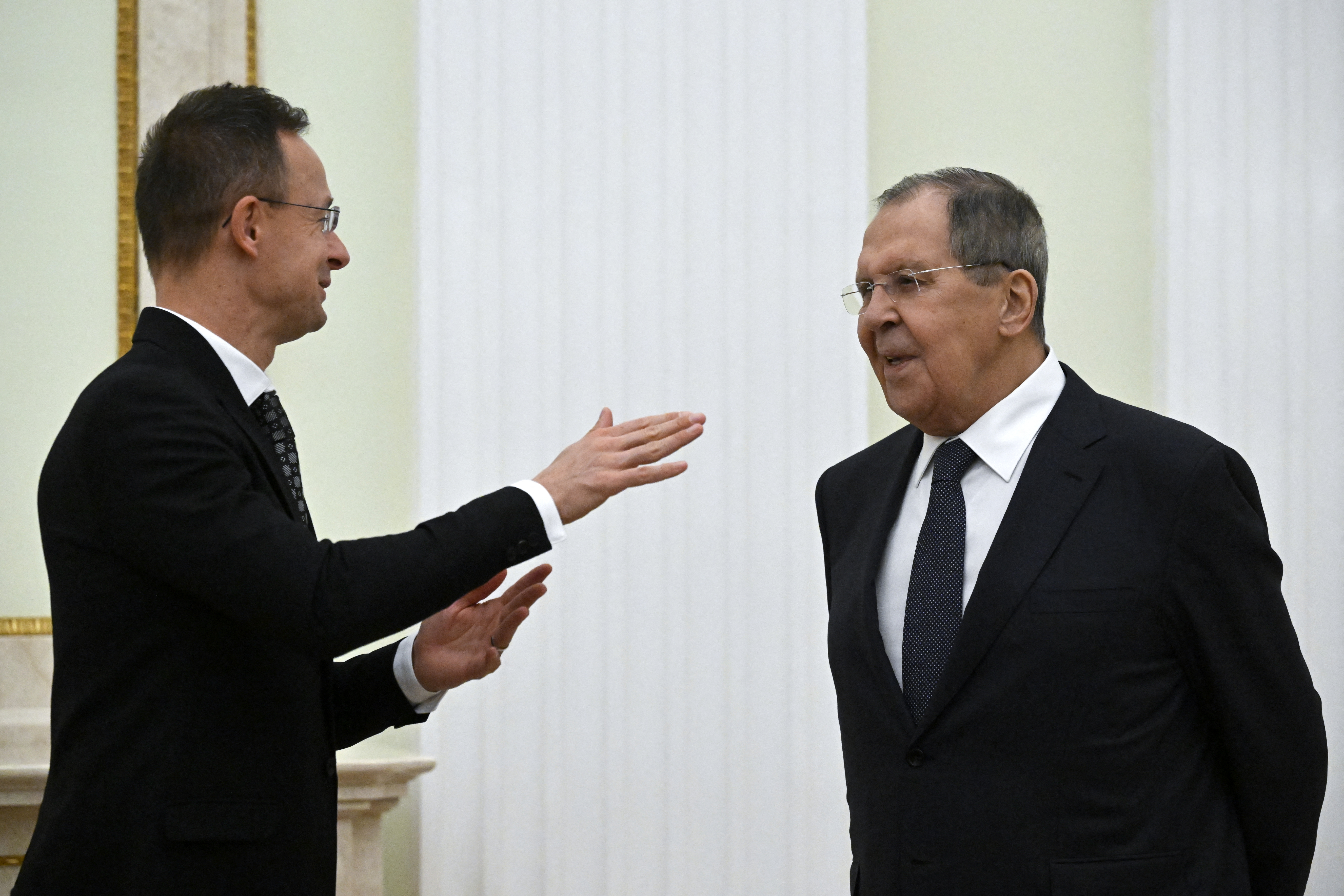 Russian Foreign Minister Sergei Lavrov and Hungarian Foreign Minister Peter Szijjarto chat prior to a meeting of Russia's President and Hungary's Prime Minister at the Kremlin in Moscow on November 28, 2025.
