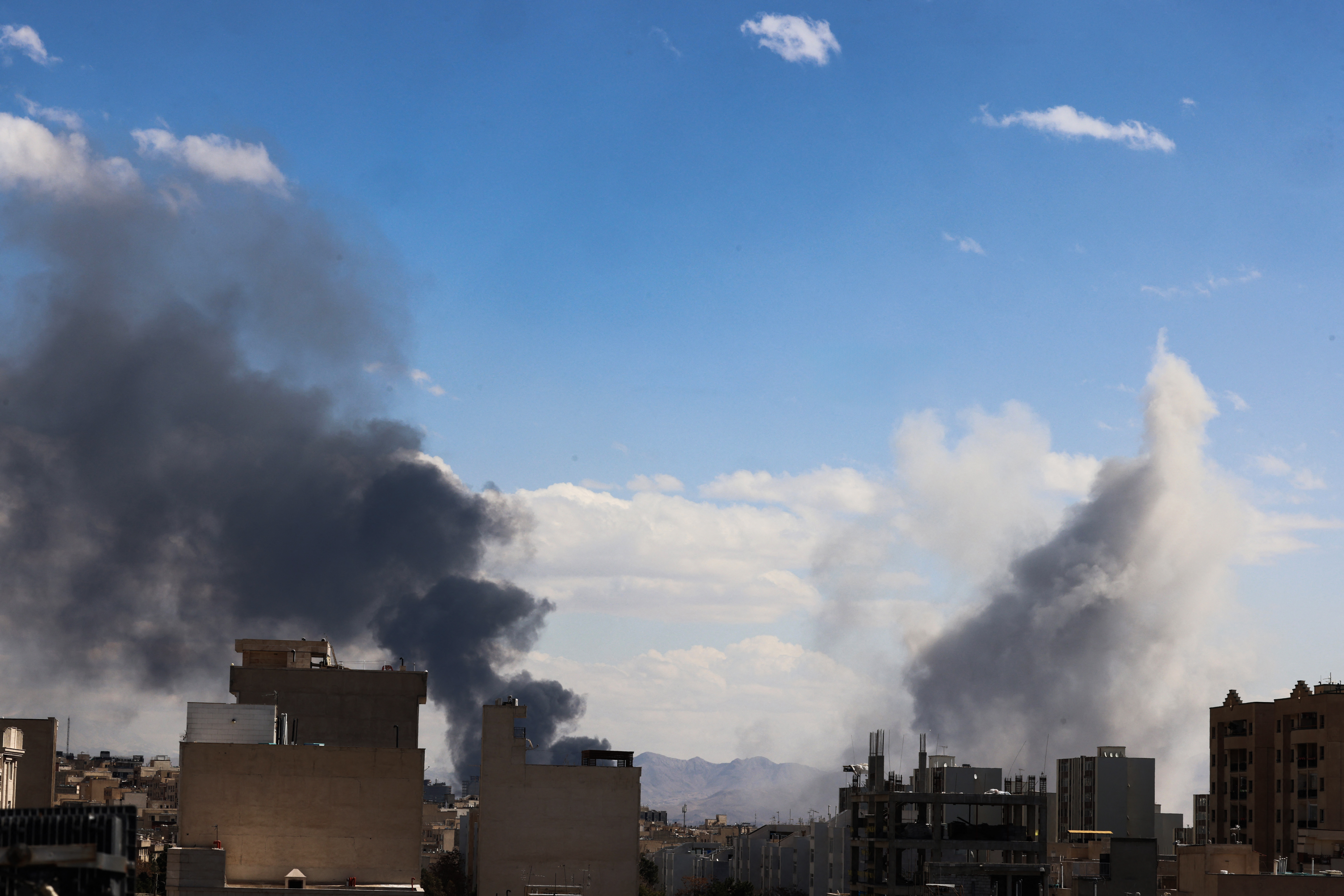 Plume of smokes rise from reported explosions in Tehran on March 1, 2026.