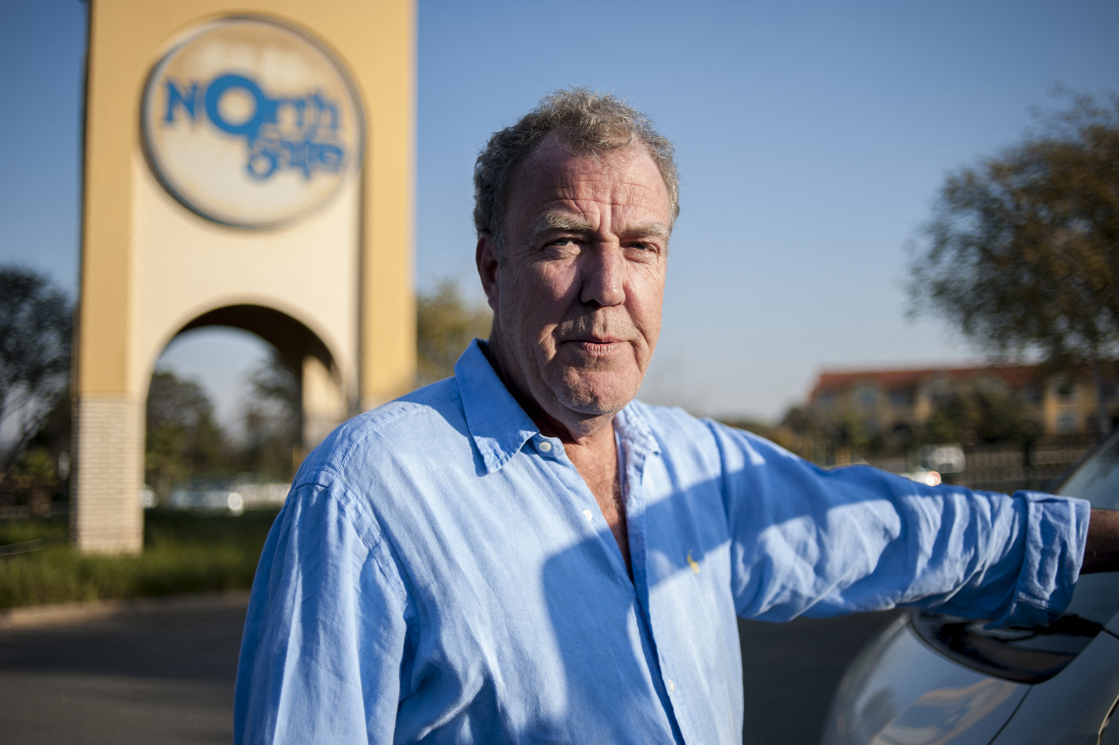 Former Top Gear presenter Jeremy Clarkson poses next to a South African taxi at the Ticketpro Dome before the Clarkson, Hammond and May Live Show held in Johannesburg on June 10, 2015. AFP PHOTO / STEFAN HEUNIS (Photo by STEFAN HEUNIS / AFP)