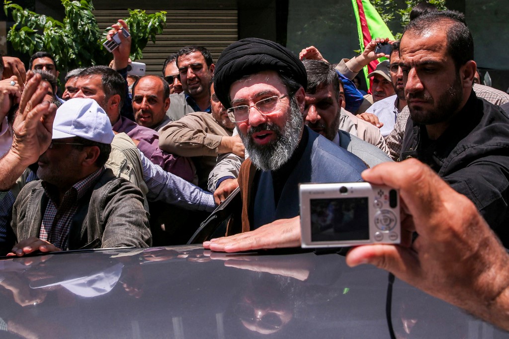 In this picture obtained from Iran's ISNA news agency, Mojtaba Khamenei, son of Iran's supreme leader Ayatollah Ali Khamenei (C), is greeted by people in Tehran on May 31, 2019. (Photo by ALI TAGHAVI / ISNA / AFP)