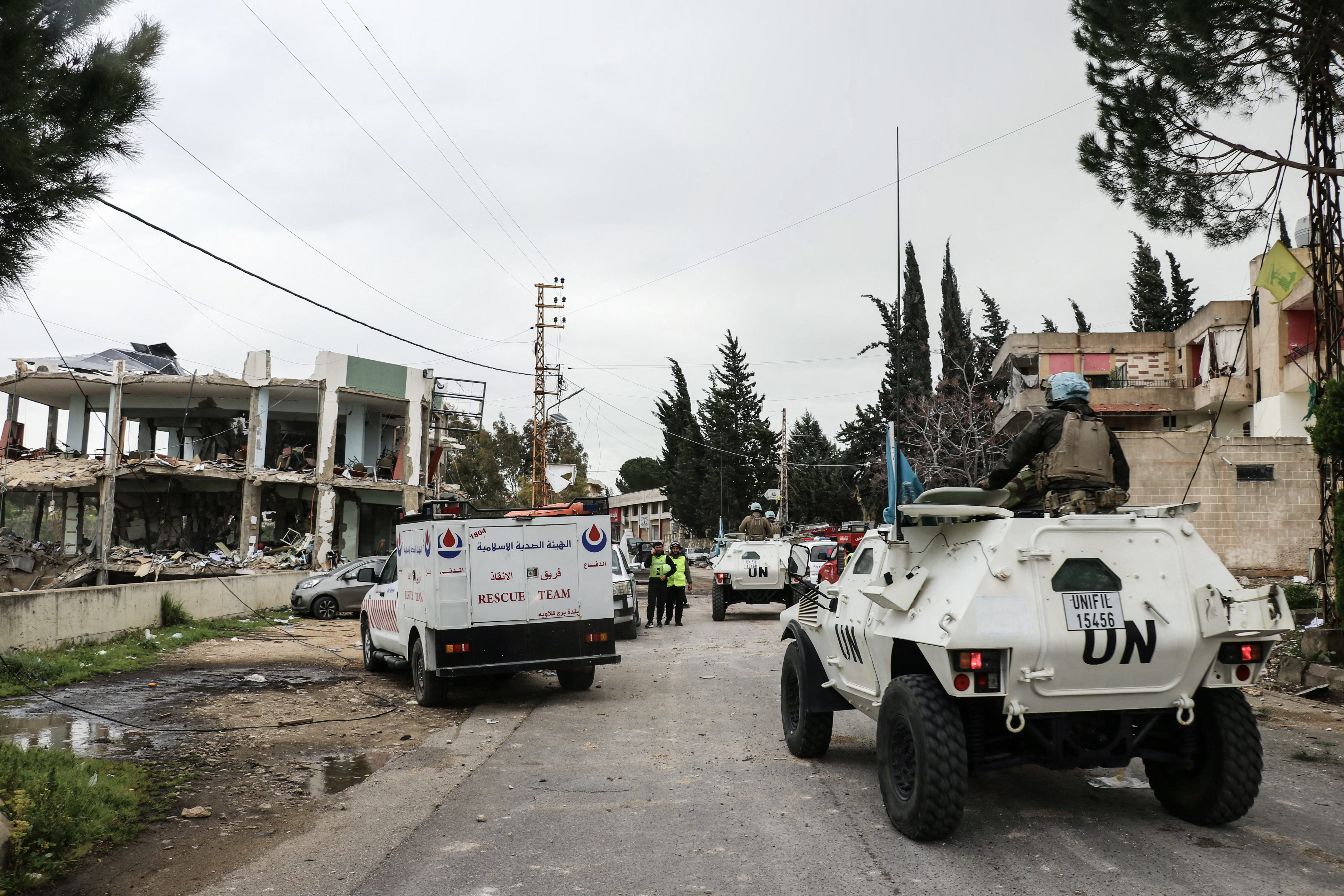 United Nations peacekeepers with the UN Interim Force in Lebanon (UNIFIL) drive past a destroyed healthcare centre building in the aftermath of an Israeli strike in the southern Lebanese town of Burj Qalawiya on March 14, 2026