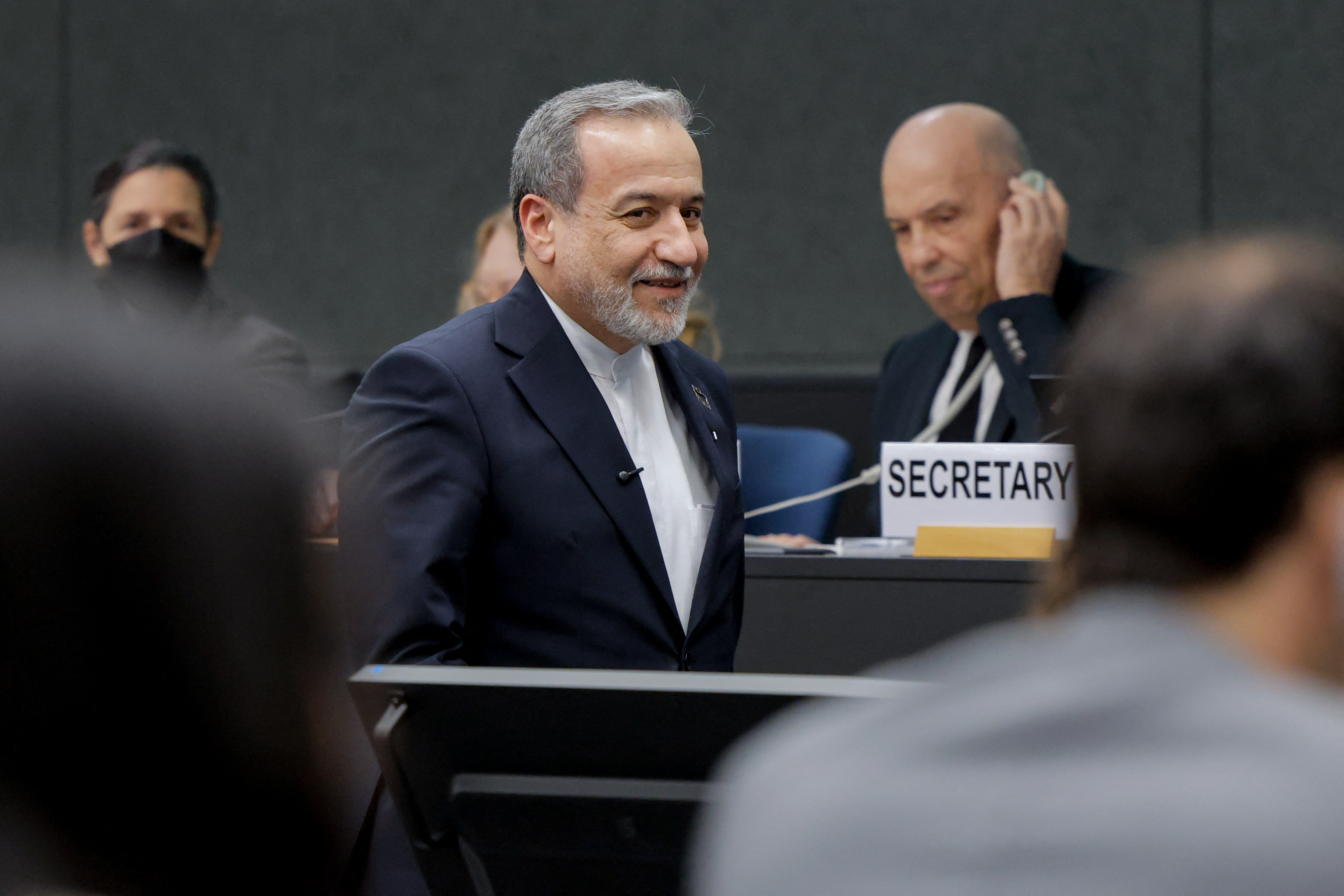 Iran's Foreign Minister Abbas Araghchi smiles upon his arrival to deliver a speech during a session of the United Nations Conference on Disarmament