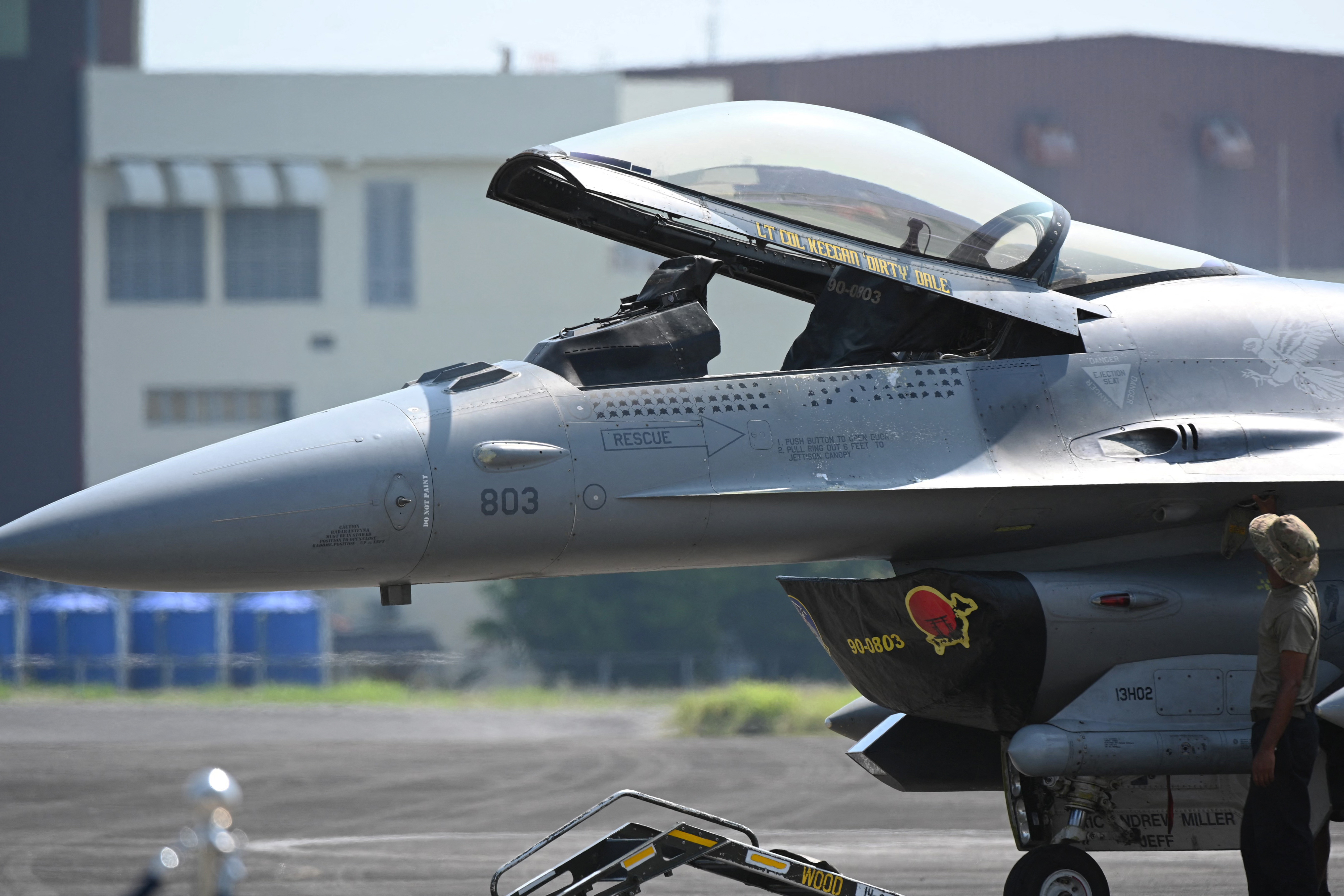 A US soldier opens the cockpit of one of their F16 fighter jets prior to the US-Philippines air force joint military exercise dubbed Cope Thunder at the former US air base Clark air base in Angeles City