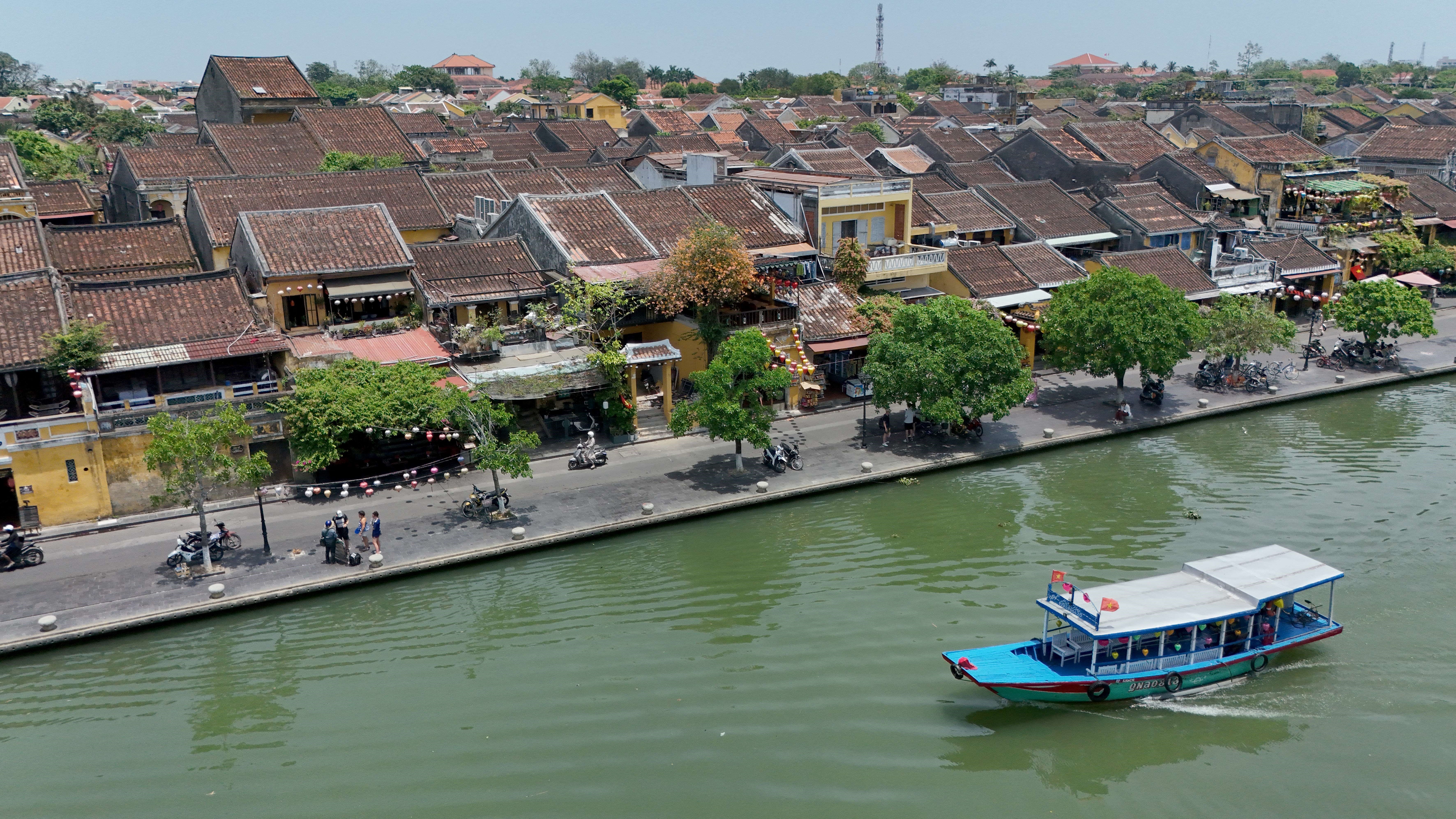 An aerial view shows the Hoai river in the ancient city of Hoi An, in Quang Nam province on April 12, 2025. Hoi An, a UNESCO world heritage site, is popular among both local and foreign tourists. (Photo by Nhac NGUYEN / AFP)