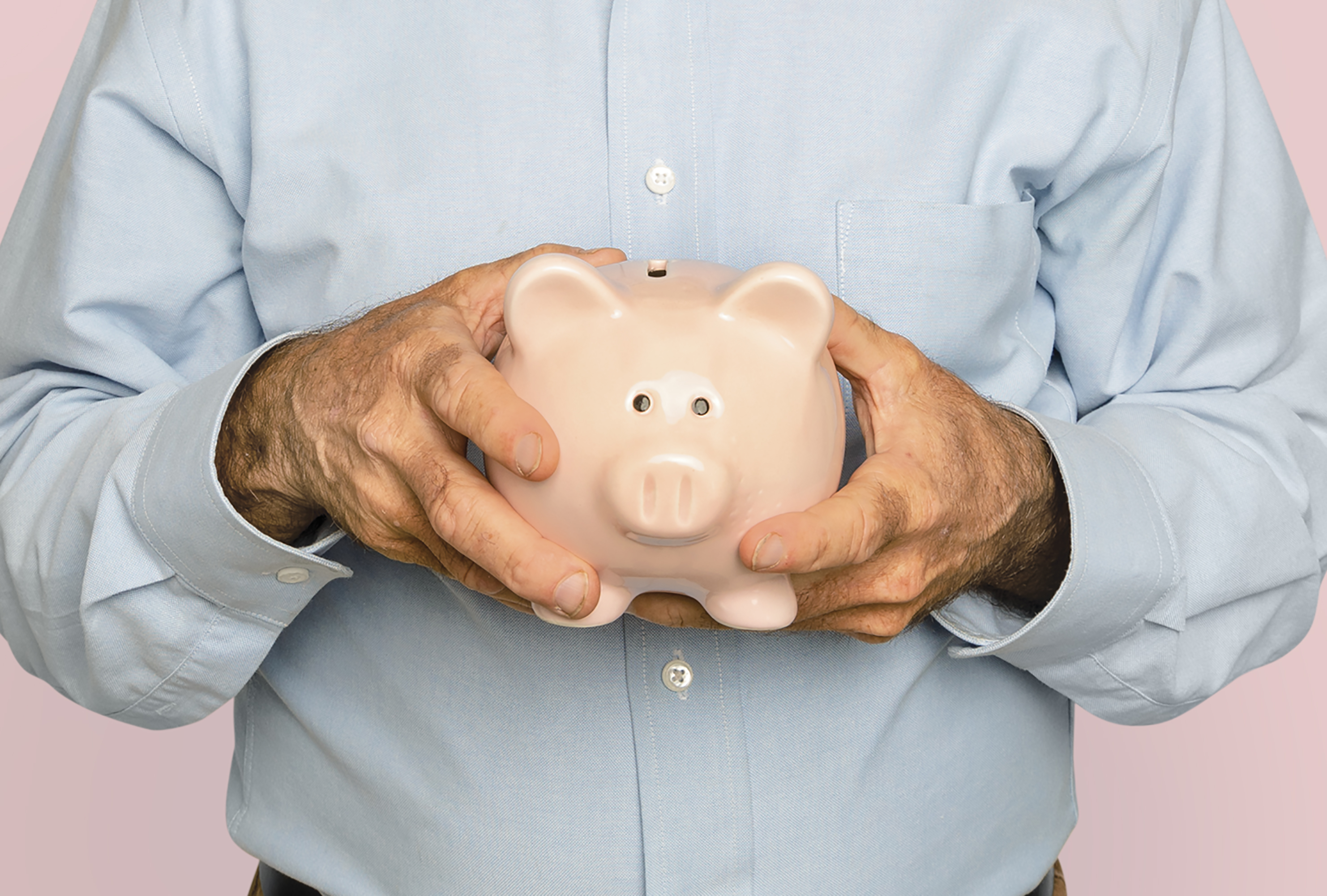 Senior man holding piggy bank for financial savings campaign