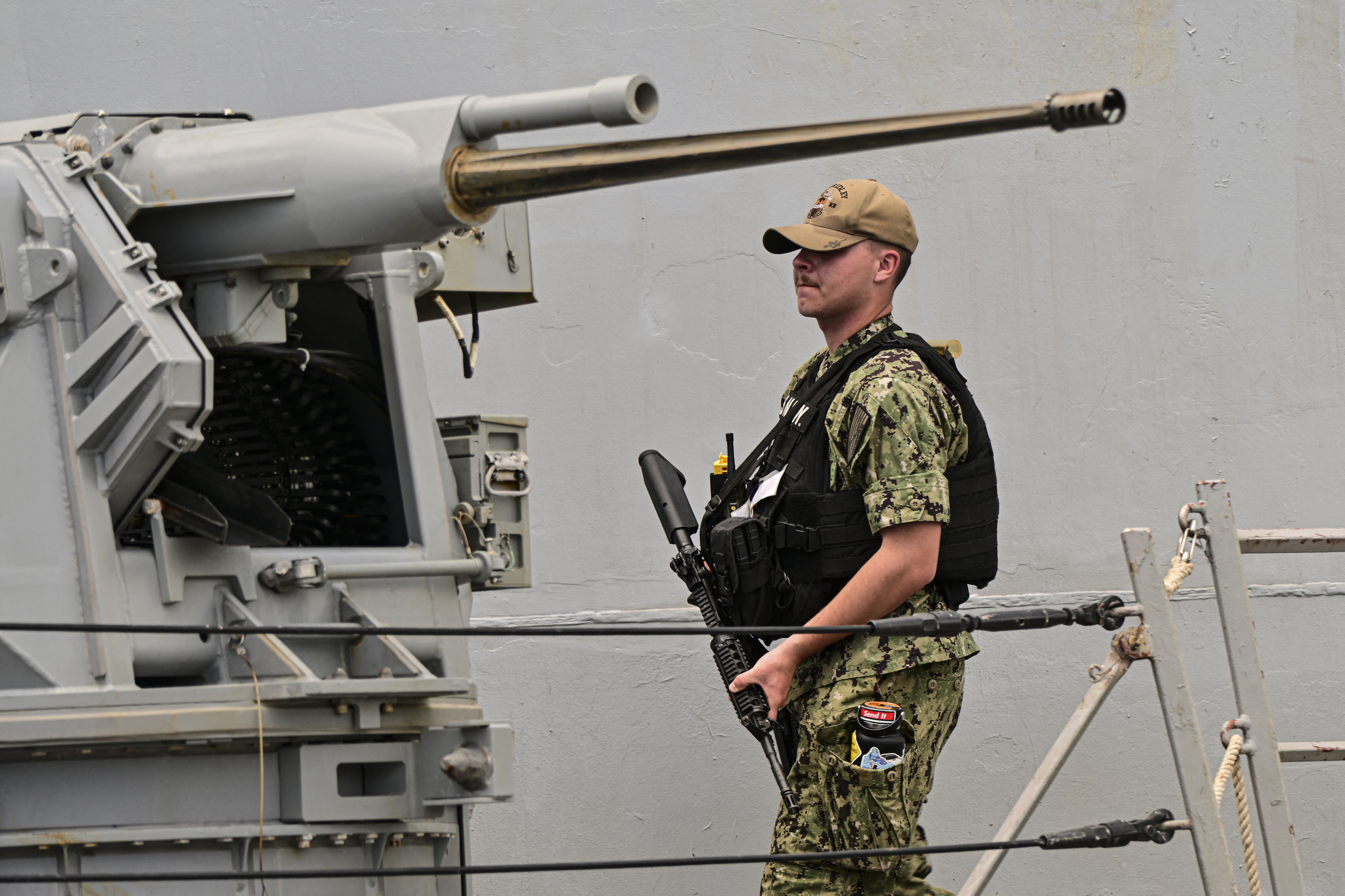 A soldier stands guard on the deck of the US Navy Arleigh Burke-class guided-missile destroyer USS Gridley (DDG 101), docked at the Amador cruise terminal in Panama City on March 29, 2026.