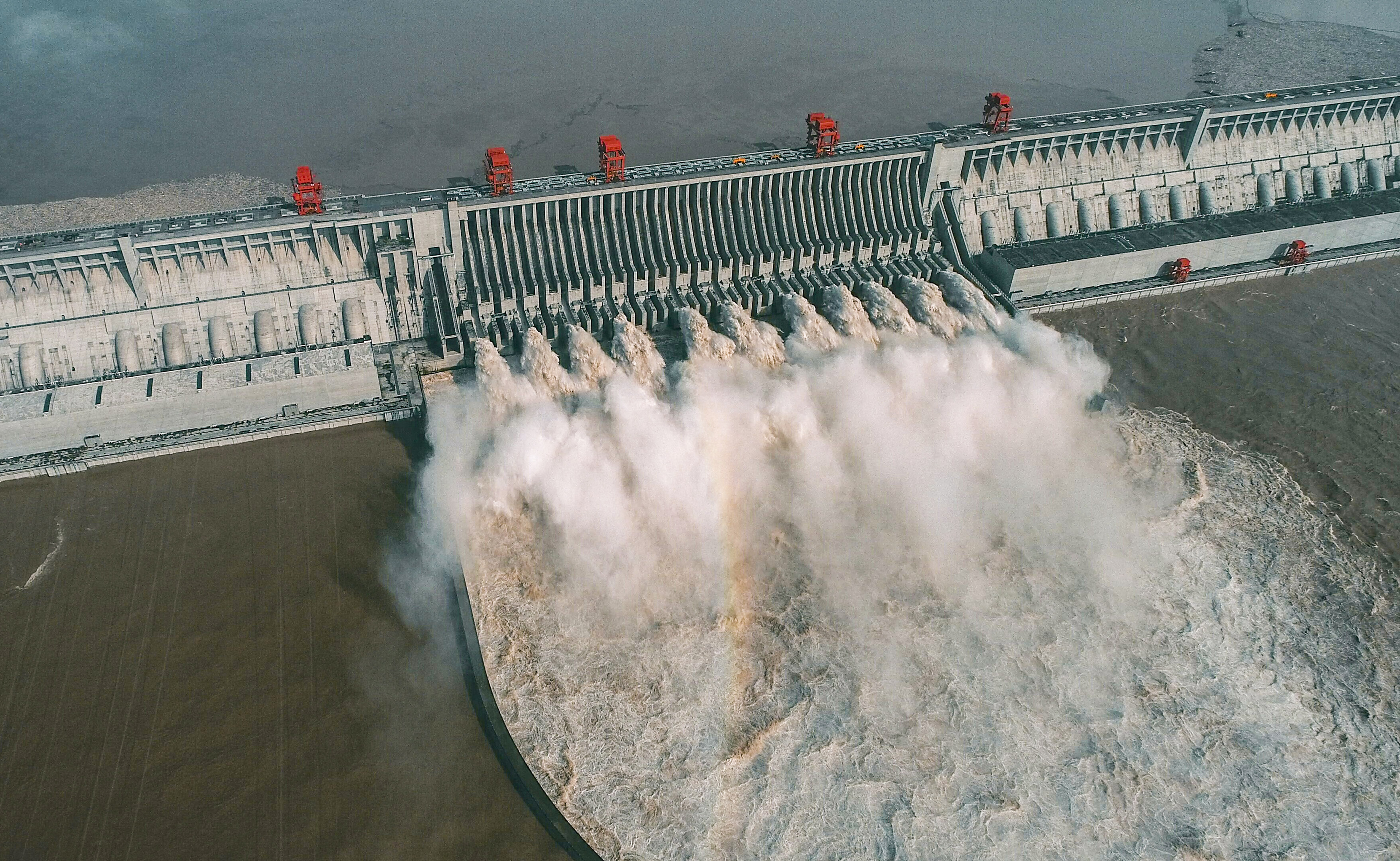 This aerial photo taken on August 23, 2020 shows water being released from the Three Gorges Dam, a gigantic hydropower project on the Yangtze river, in Yichang, central China's Hubei province. (Photo by CN-STR / AFP) / China OUT