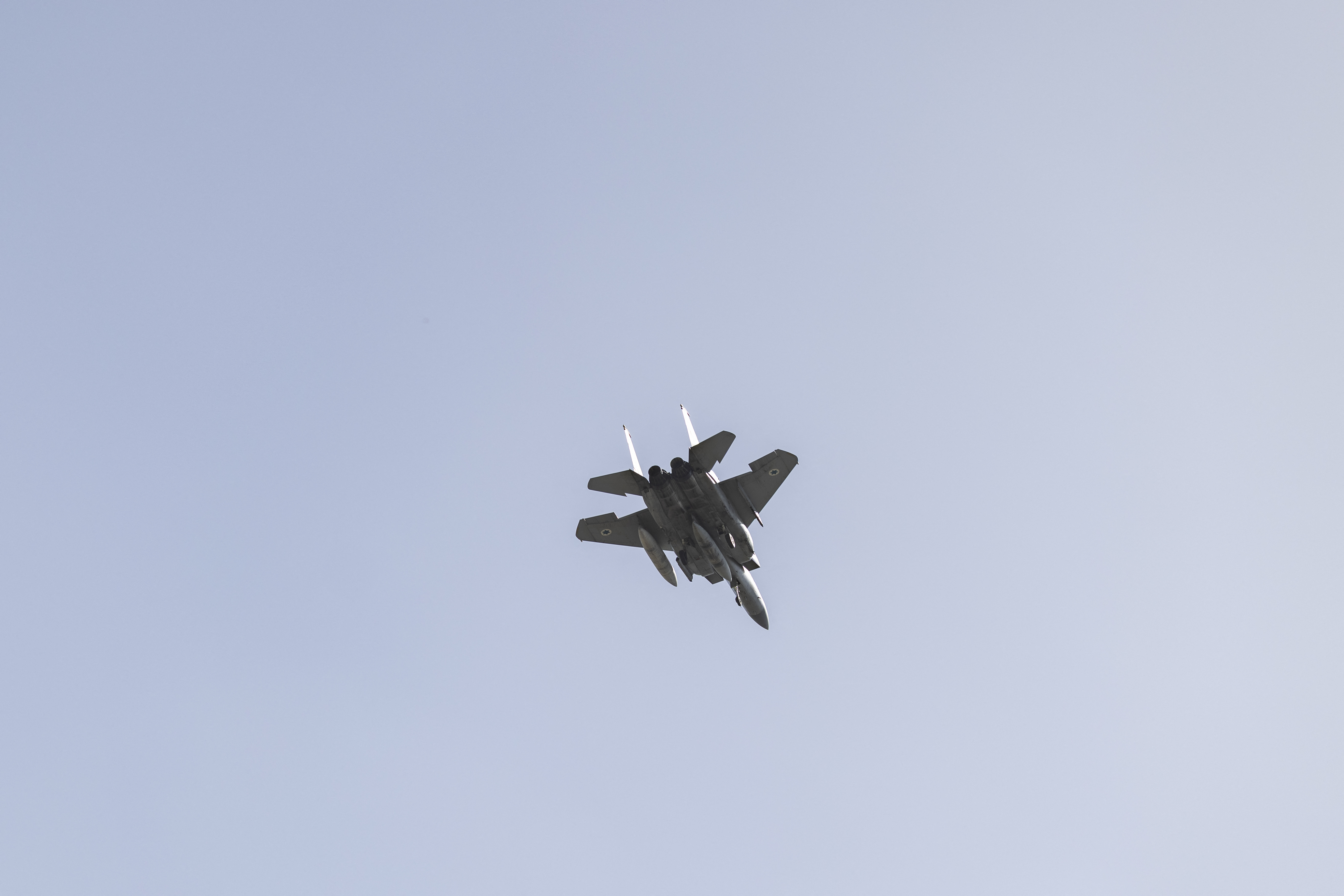 An Israeli Air Force F-15 fighter jet flies over the outskirts of Tel Aviv on March 20, 2026.