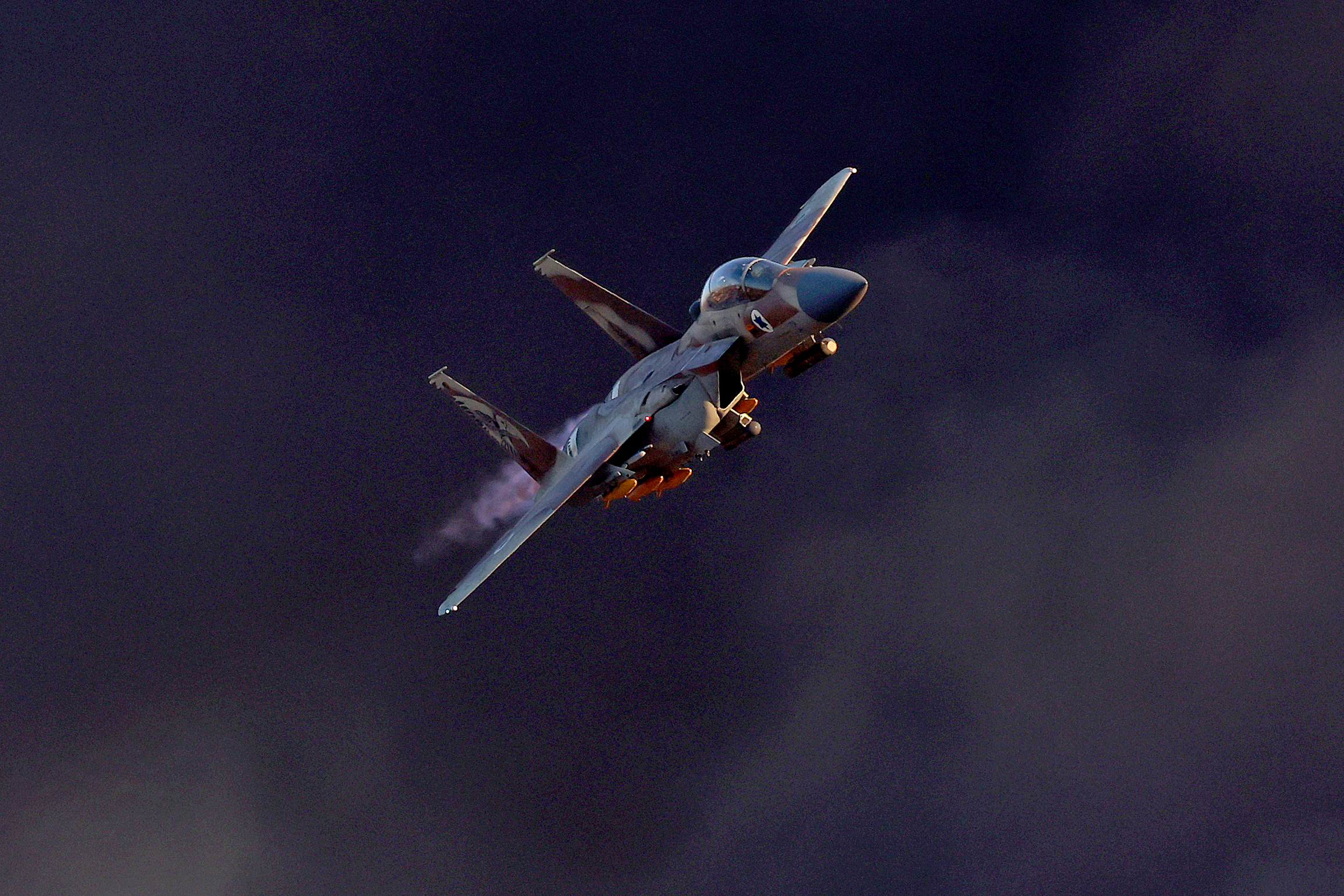 (FILES) Israel's F-15E Strike Eagle fighter plane performs maneuvers during the graduation ceremony of Israeli Air Force pilots at the Hatzerim base in the Negev desert, near the southern city of Beer Sheva