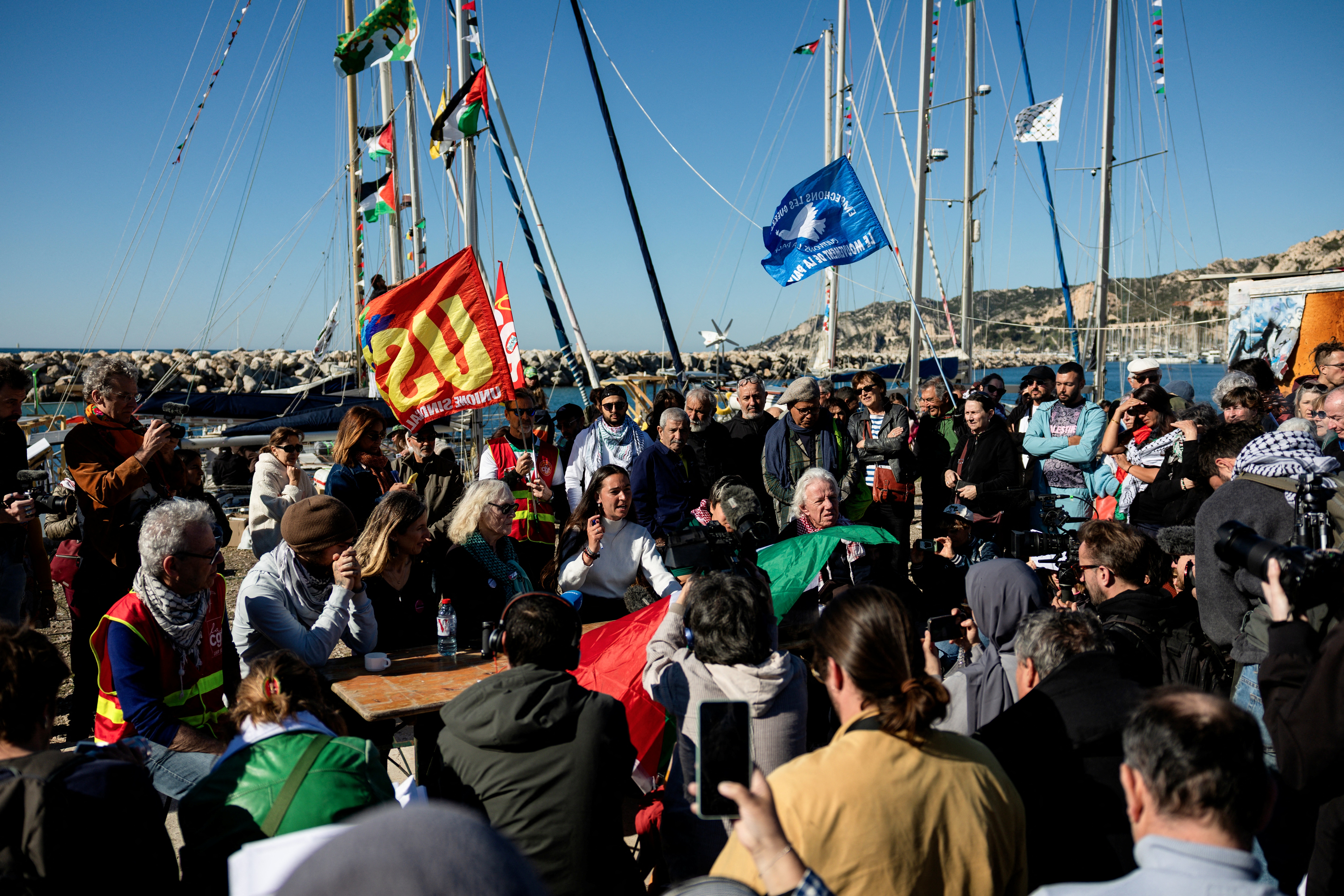 People attend a press conference in l'Estaque, part of Marseille's harbour, southern France, on April 4, 2026, during a rally in support of a flotilla carrying activists from “Thousand Madleens to Gaza”