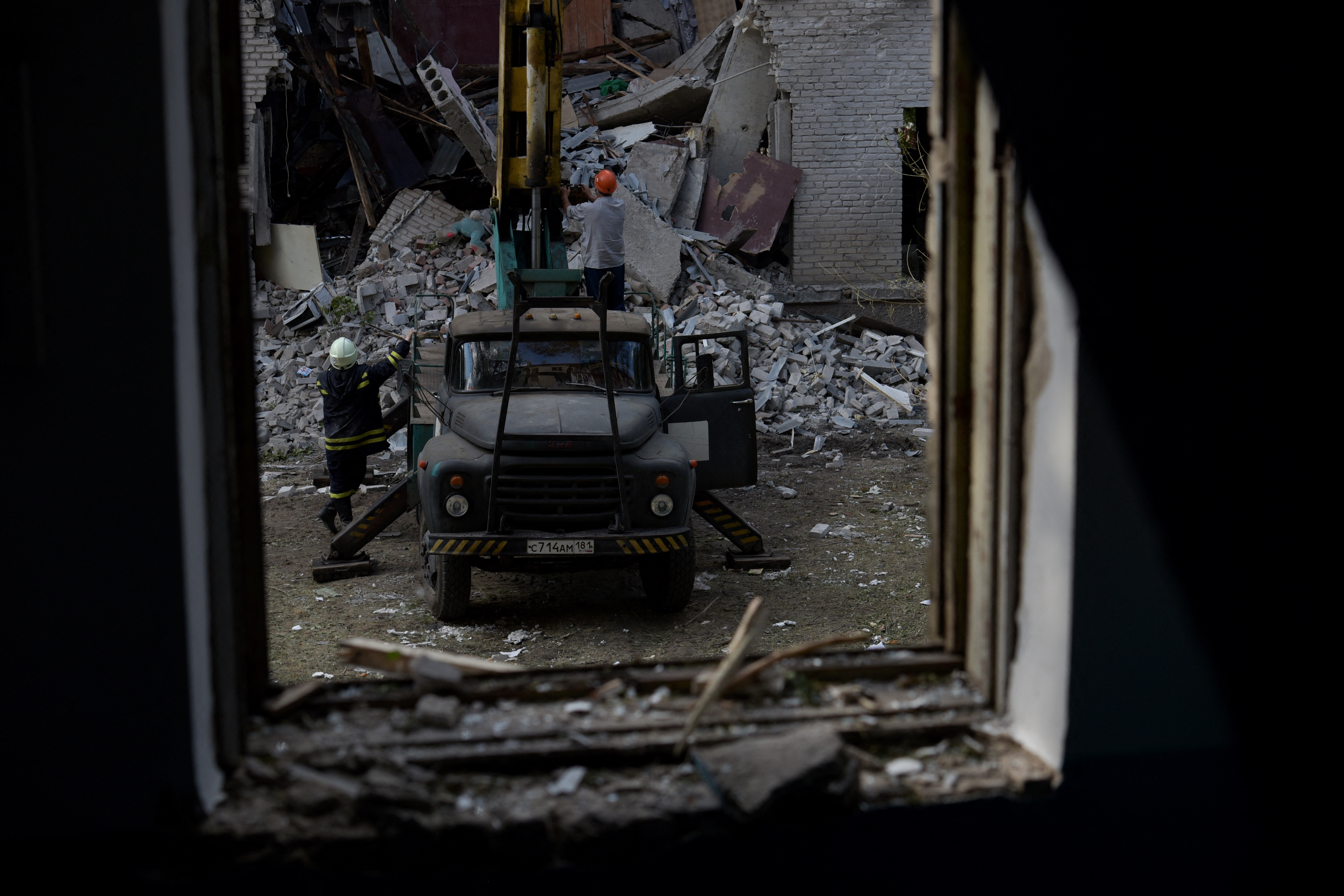 Rescuers clear the rubble of a destroyed residential building following a missile attack in Lugansk, Russian-controlled Ukraine, on June 7, 2024