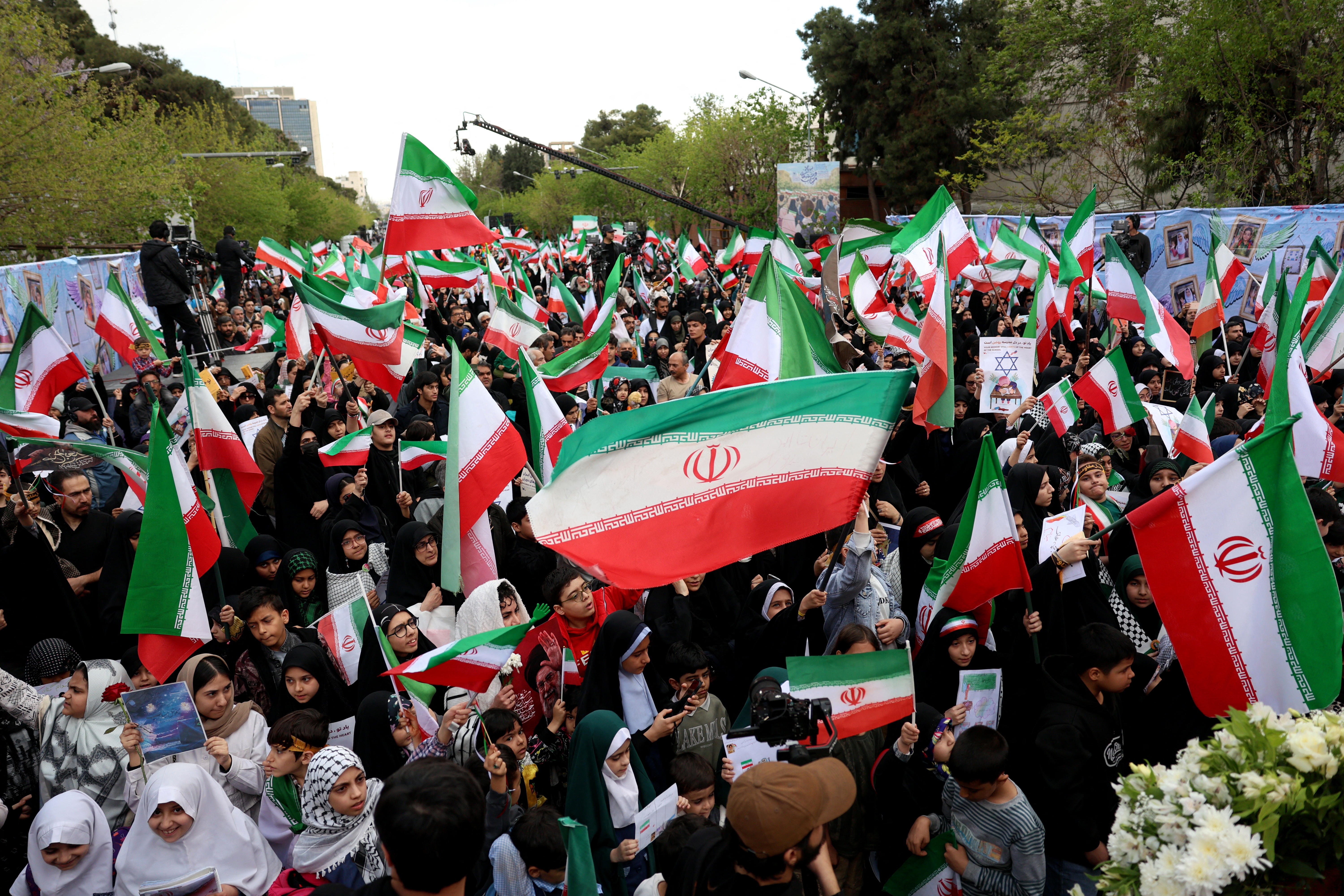 Iranians rally during a memorial, 40 days after a deadly strike on a children’s school in the southern city of Minab on the first day of the war that killed at least 165 people, most of them children, in Tehran on April 7, 2026.