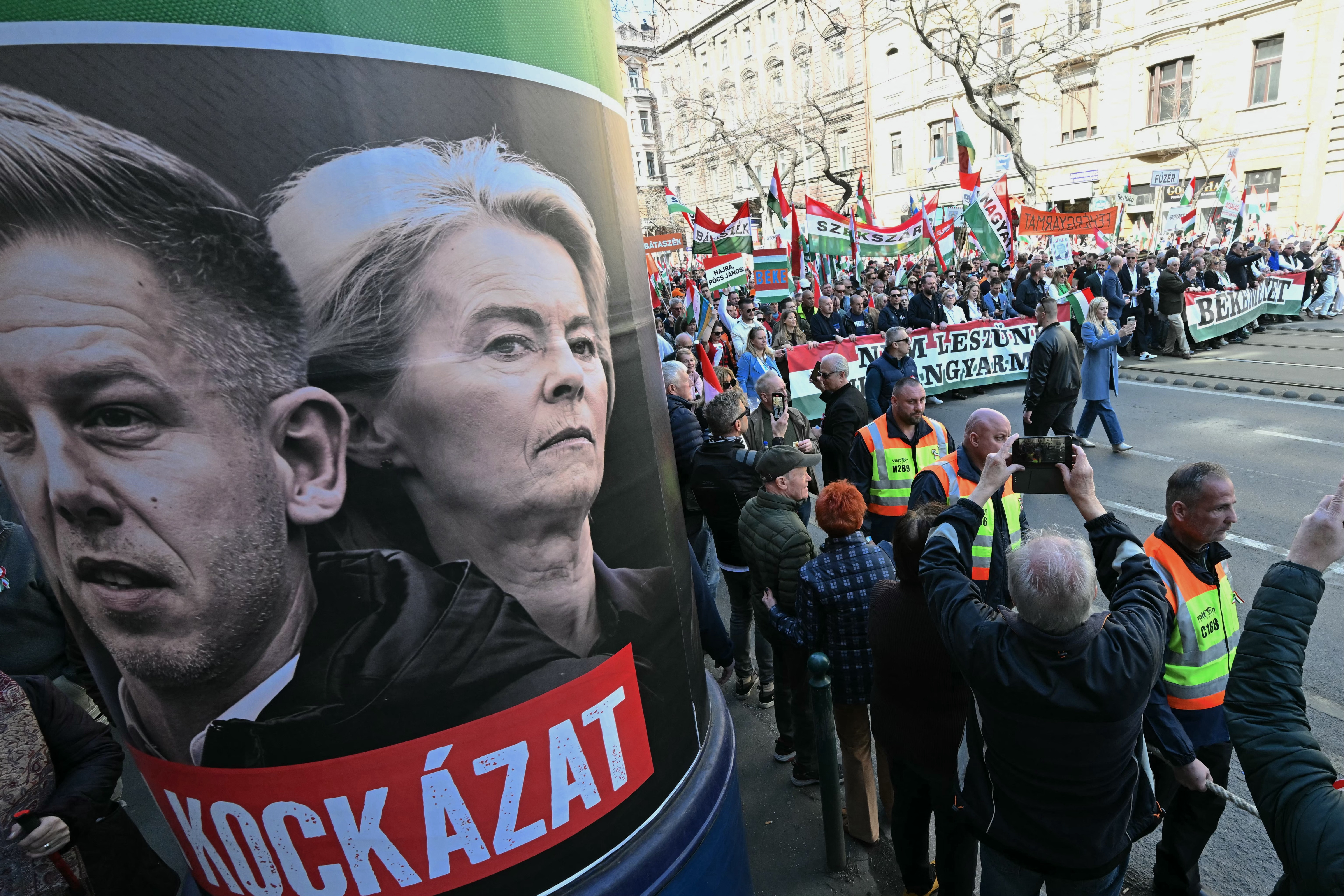 poster showcasing Hungarian opposition leader and president of the TISZA party Peter Magyar (L) with European Commission President Ursula von der Leyen (2nd L) (Photo by Attila KISBENEDEK / AFP)