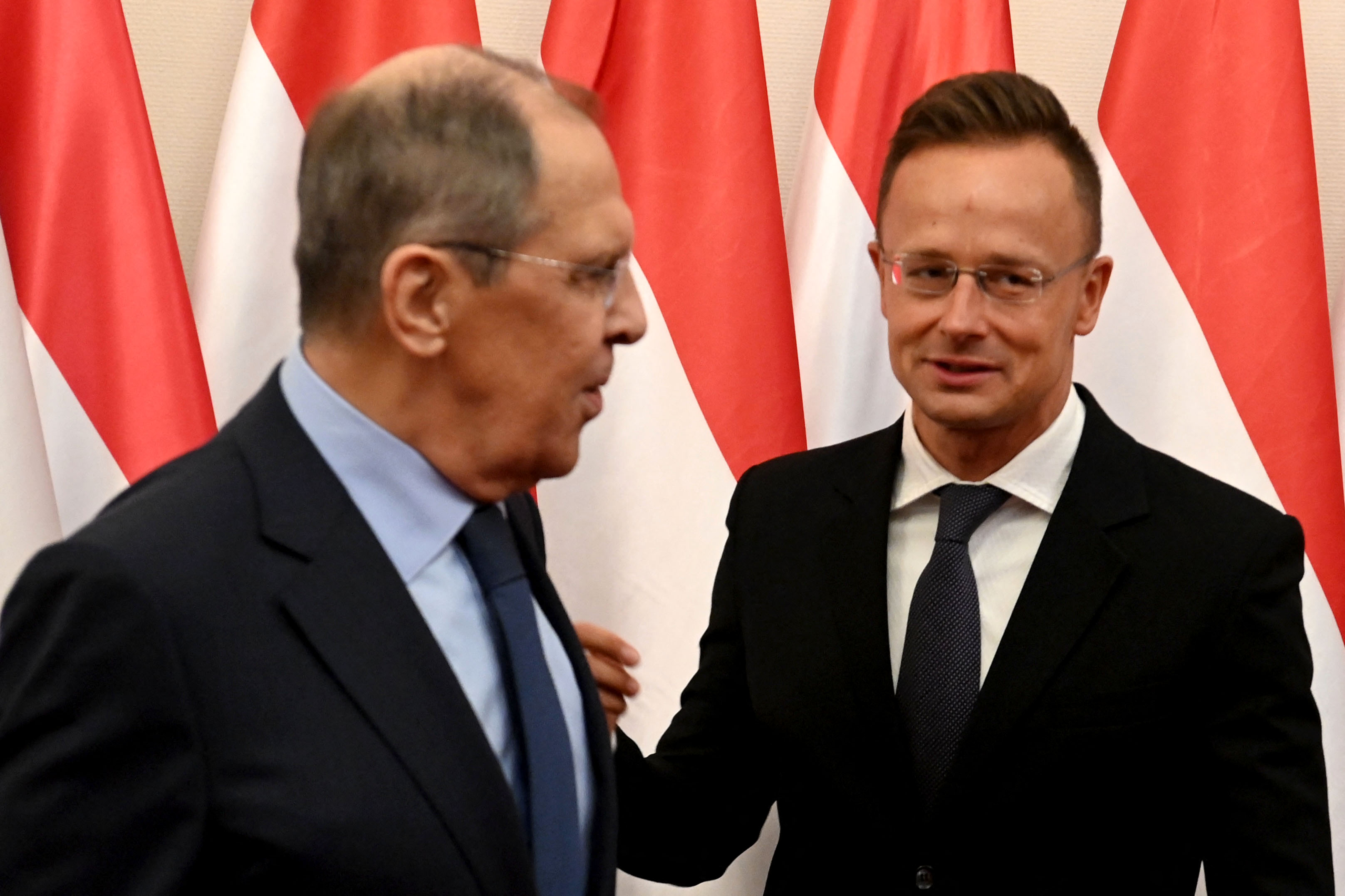 Russian Foreign Minister Sergey Lavrov (L) talks with Hungary's Foreign and Trade Minister Peter Szijjarto during their meeting in Budapest, Hungary on August 24, 2021. Lavrov is on a one-day working visit in Hungary. (Photo by Attila KISBENEDEK / AFP)