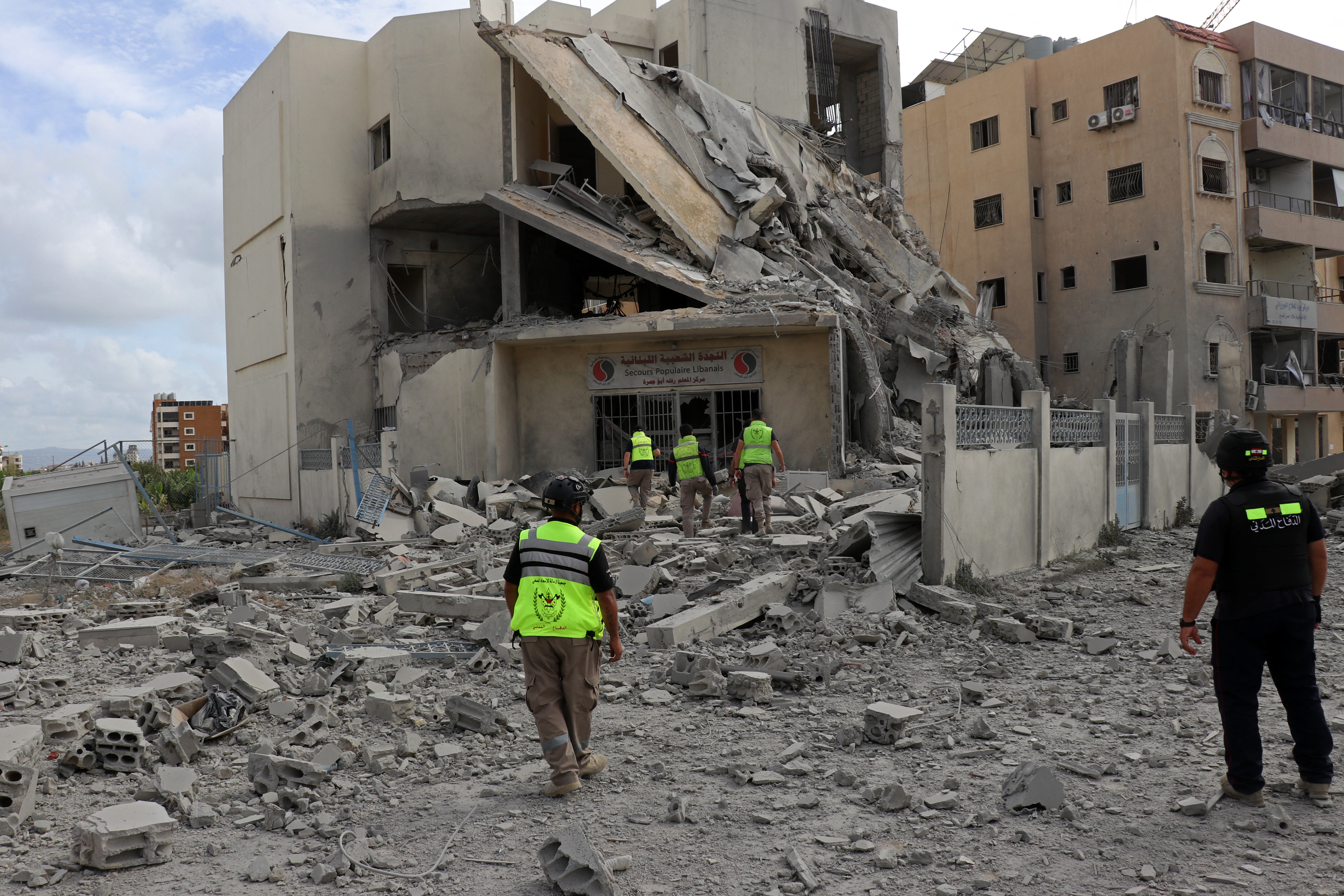 First responders inspect the destruction at the site of an Israeli airstrike that targeted the headquarters of a local NGO, in the southern coastal city of Tyre on May 15, 2026.