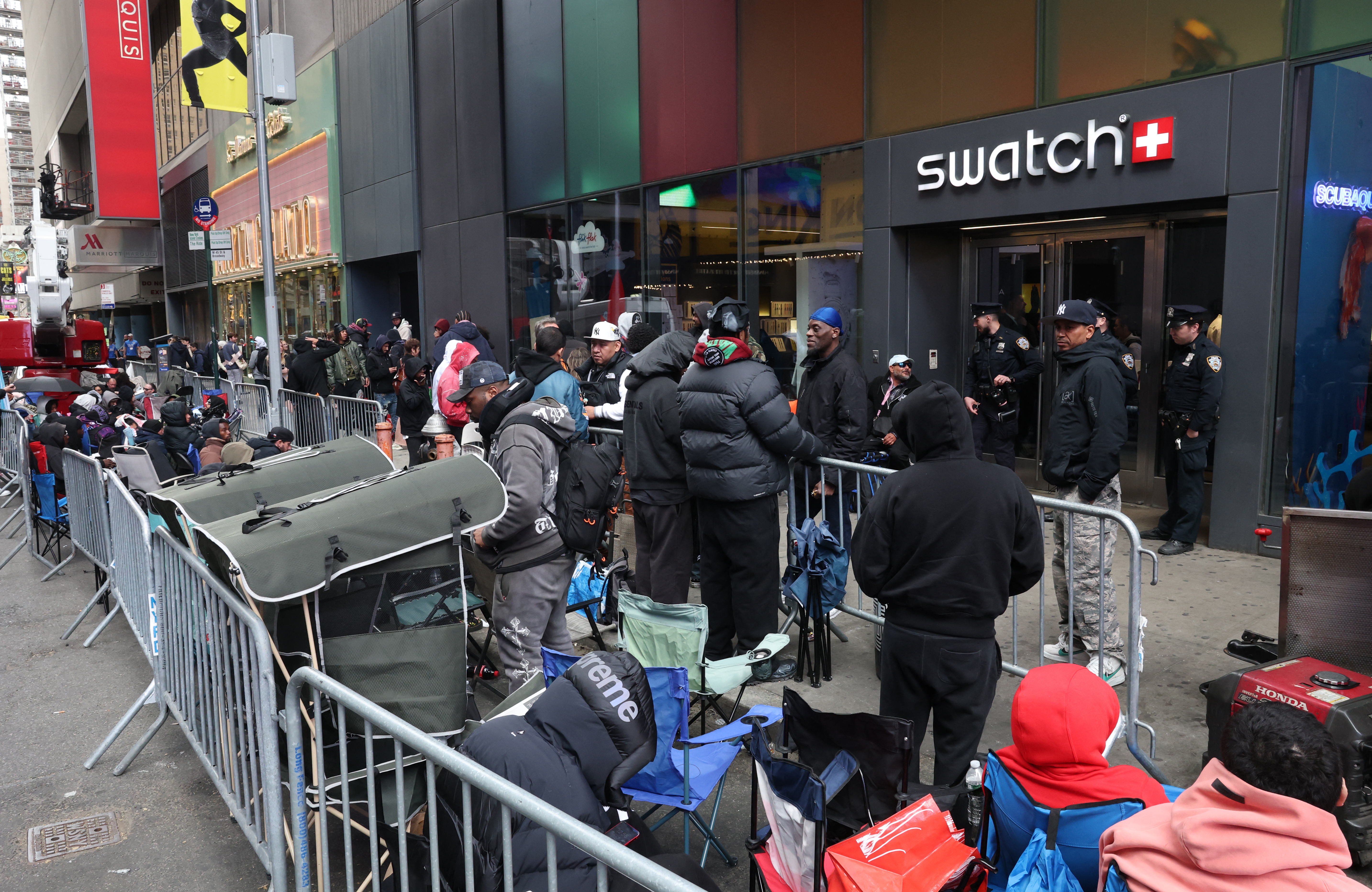 People camping out in line outside of the Swatch store in Times Square in New York. (Photo by TIMOTHY A. CLARY / AFP)