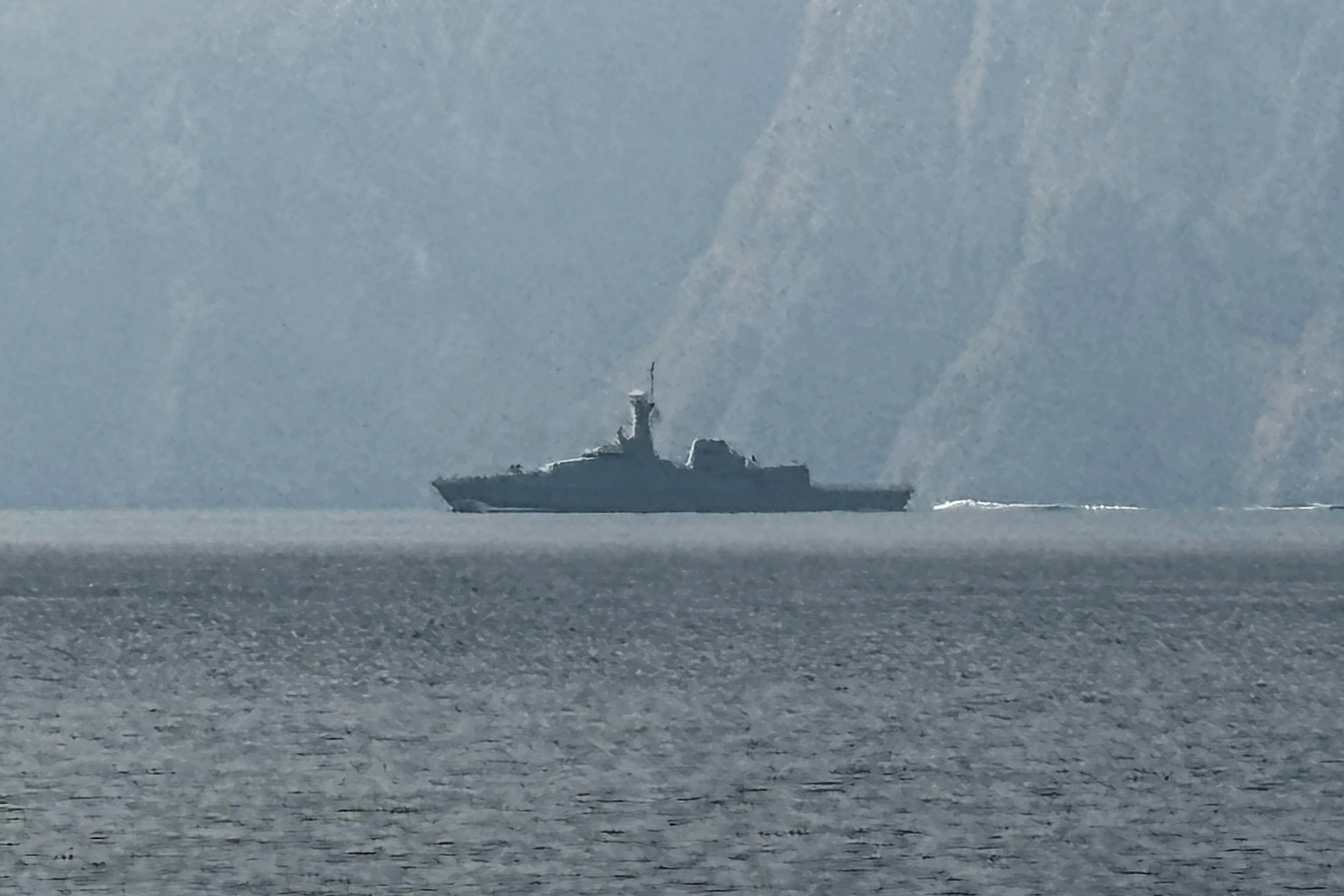 A navy vessel is seen sailing in the Strait of Hormuz, a vital waterway through which much of the world's oil and gas passes on March 1, 2026.