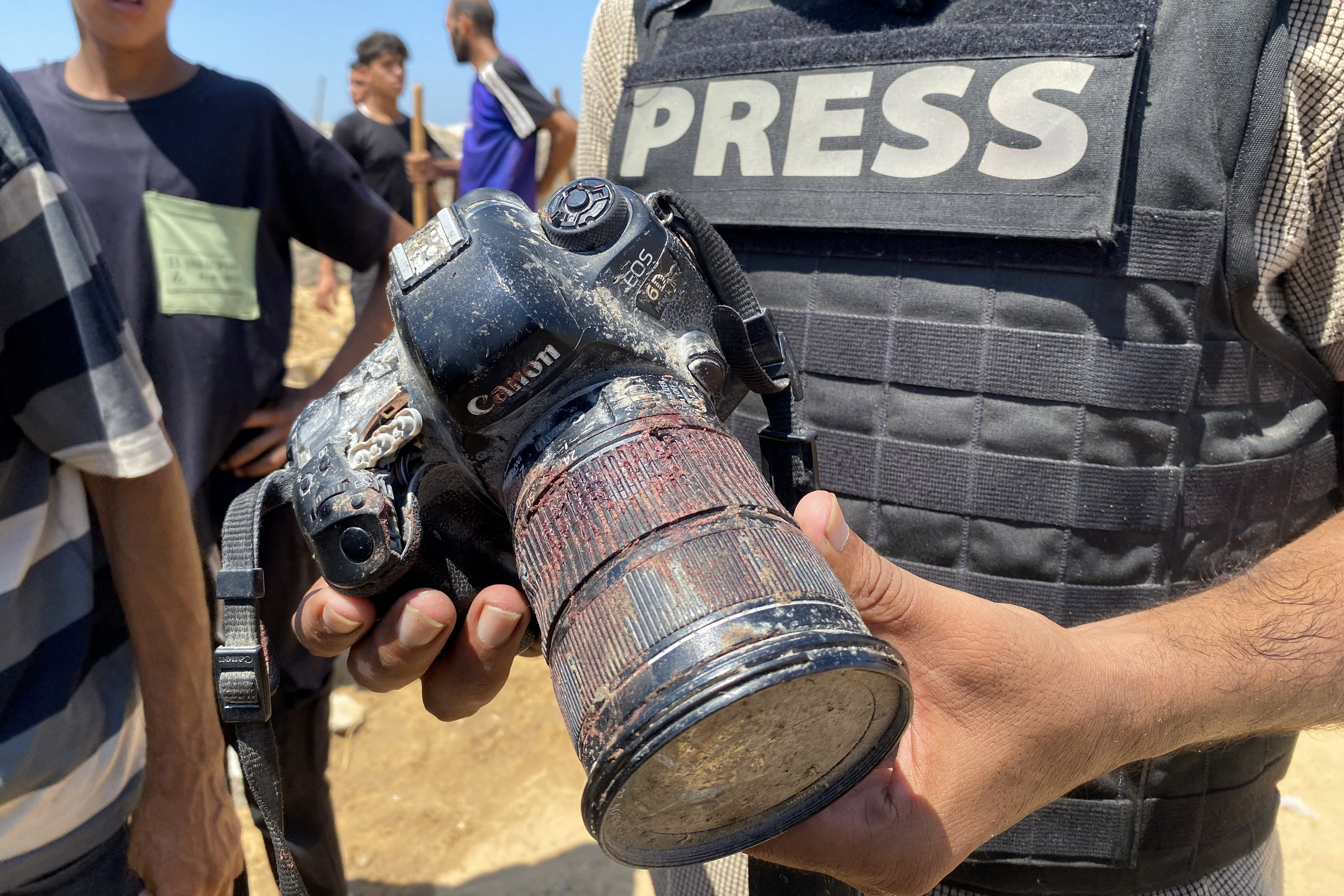 A journalist holds the blood-covered camera belonging to Palestinian photojournalist Mariam Dagga, a journalist who freelanced for AP since the start of the war and who was killed in an Israeli strike on Nasser hospital in Khan Yunis