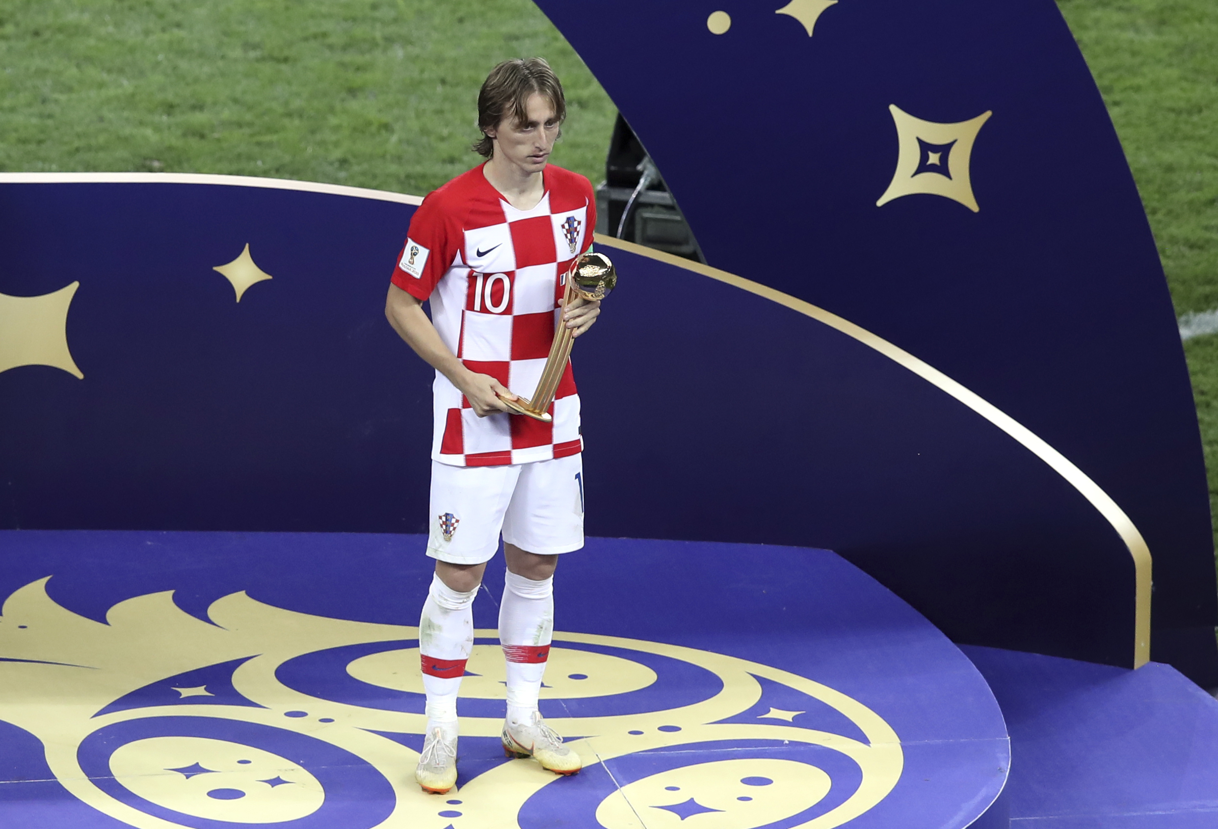 Croatia's Luka Modric holds his Golden Ball award Sunday, July 15, 2018. (AP Photo/Thanassis Stavrakis)