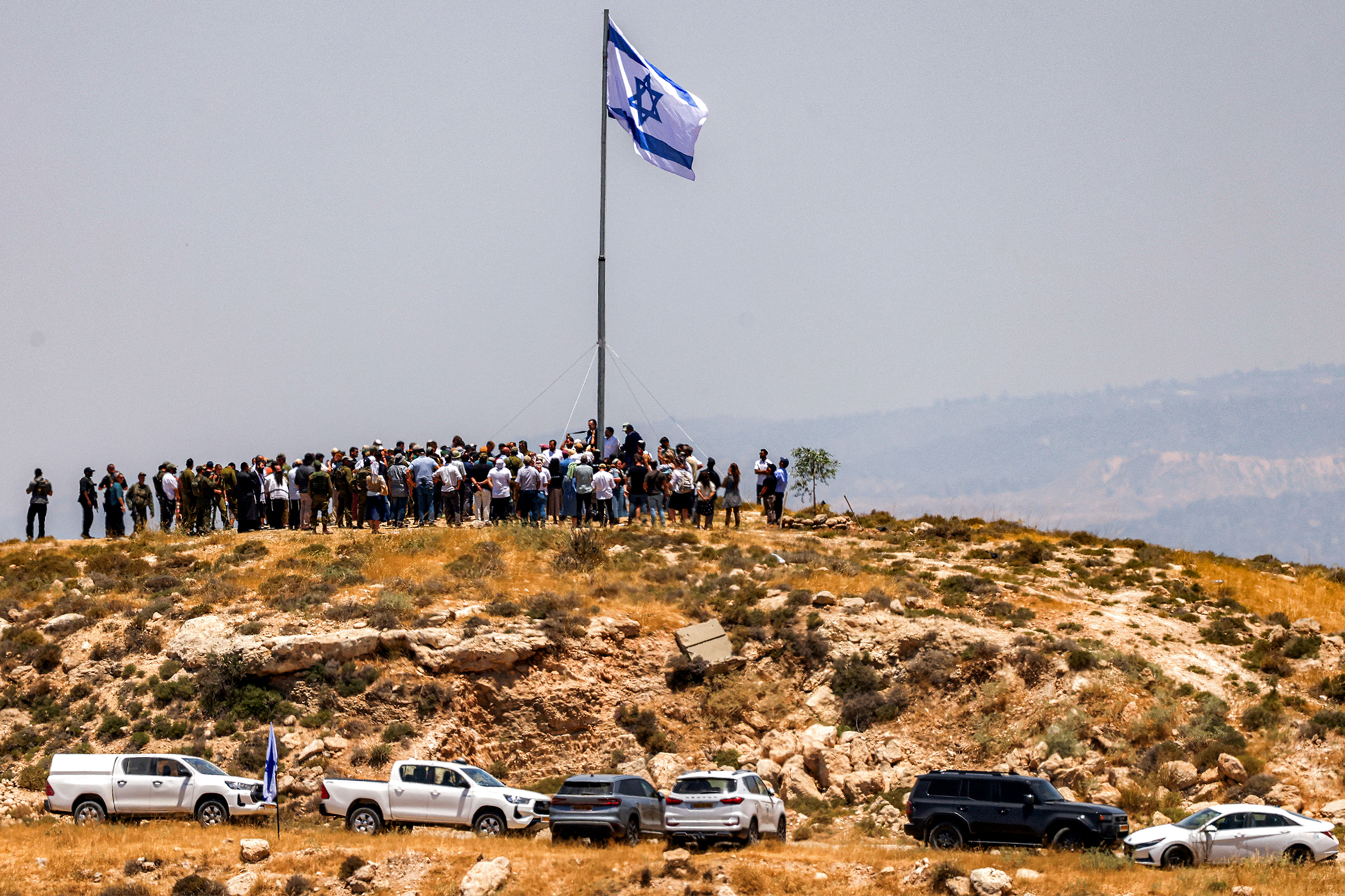 Israeli settlers, accompanied by Israel's far-right finance minister Bezalel Smotrich. (Photo by HAZEM BADER / AFP)