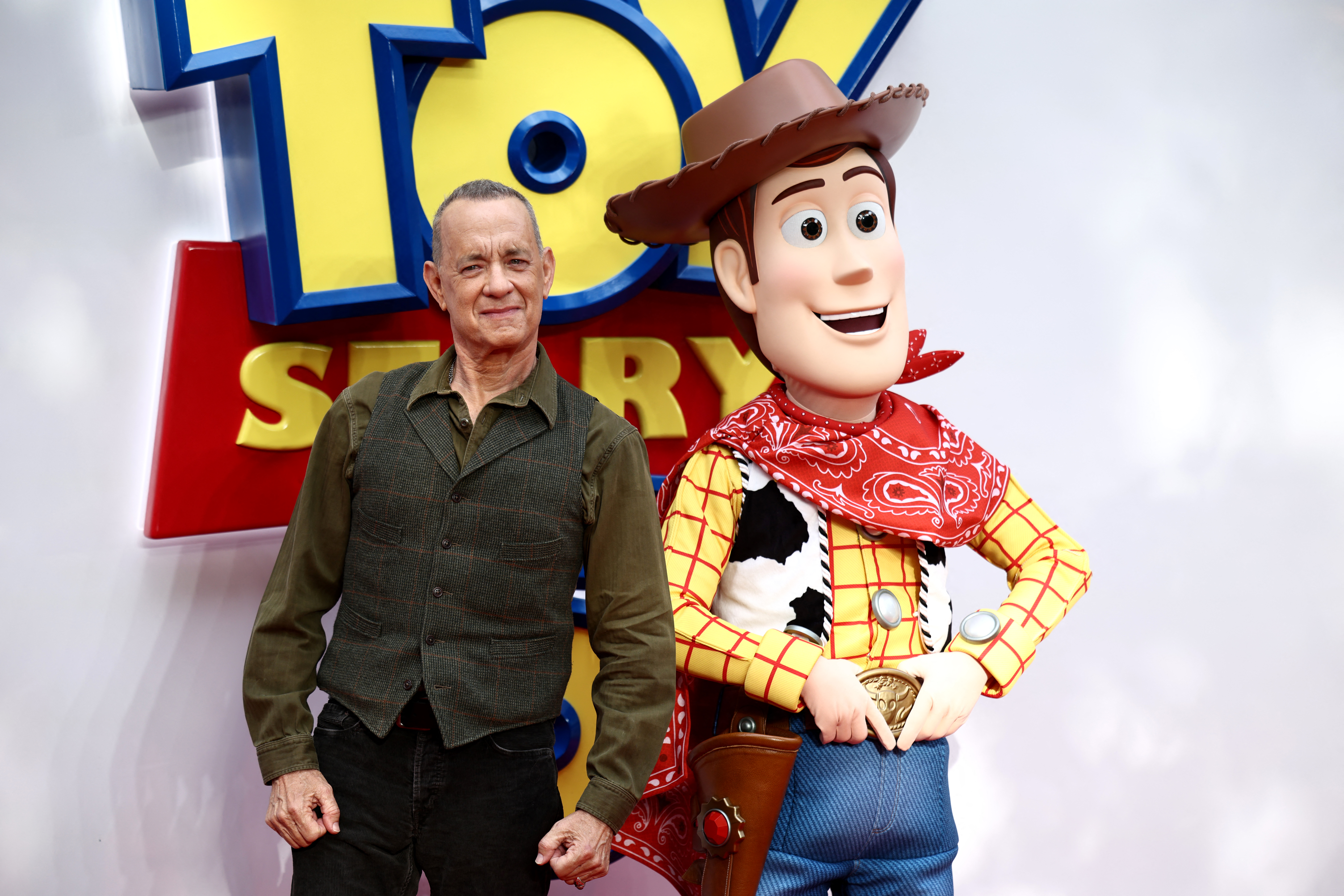 US actor Tom Hanks poses with his character Woody, upon arrival to attend the red carpet for the UK launch event of the film 'Toy Story 5' in London on May 28, 2026. (Photo by Henry NICHOLLS / AFP)