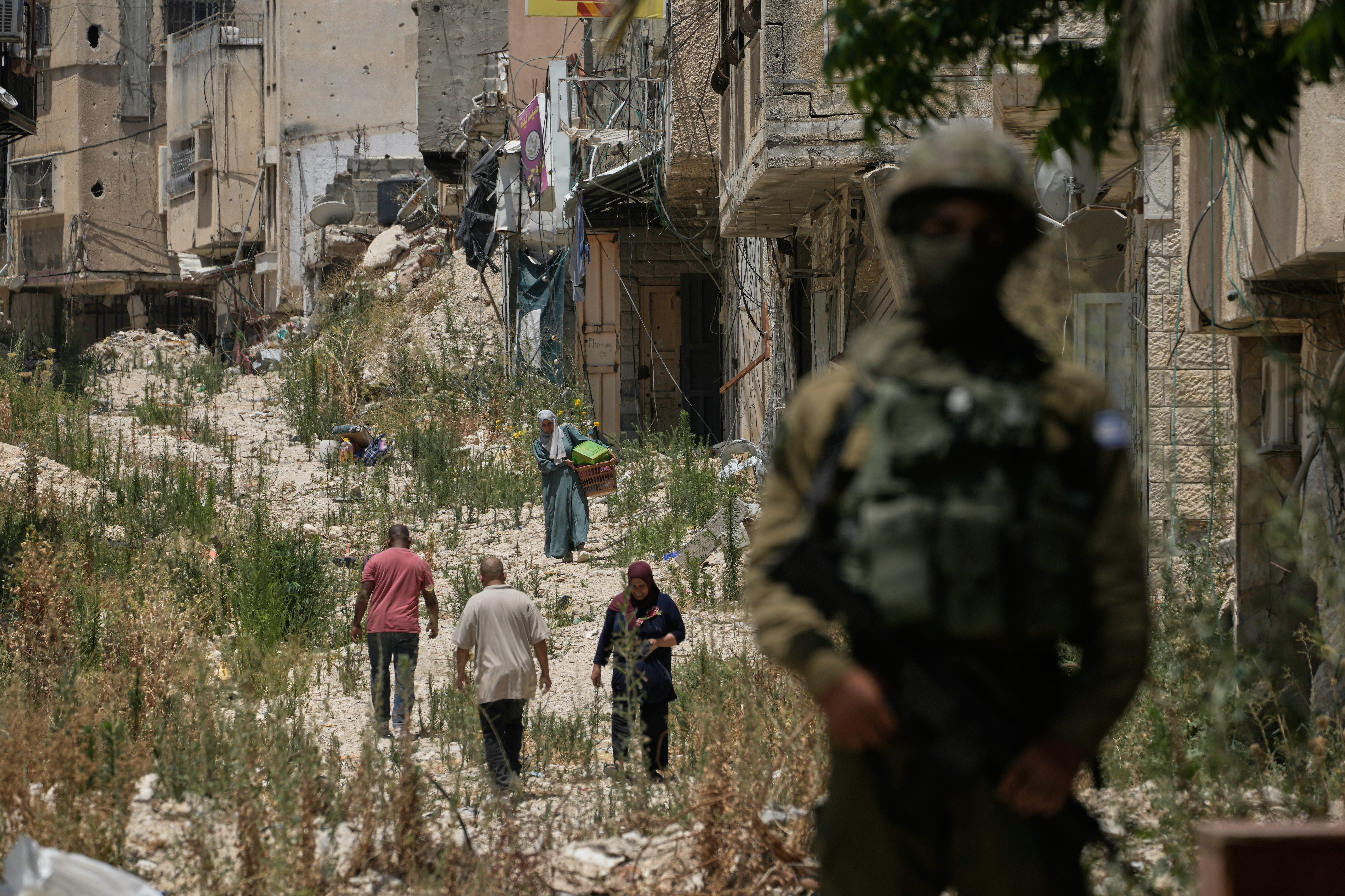 Palestinians collect their belongings from their evacuated homes after the Israeli army issued a number of short term access permits for residents of the occupied West Bank refugee camp of Tulkarem, Wednesday, June 17, 2026. (AP Photo/Majdi Mohammed)