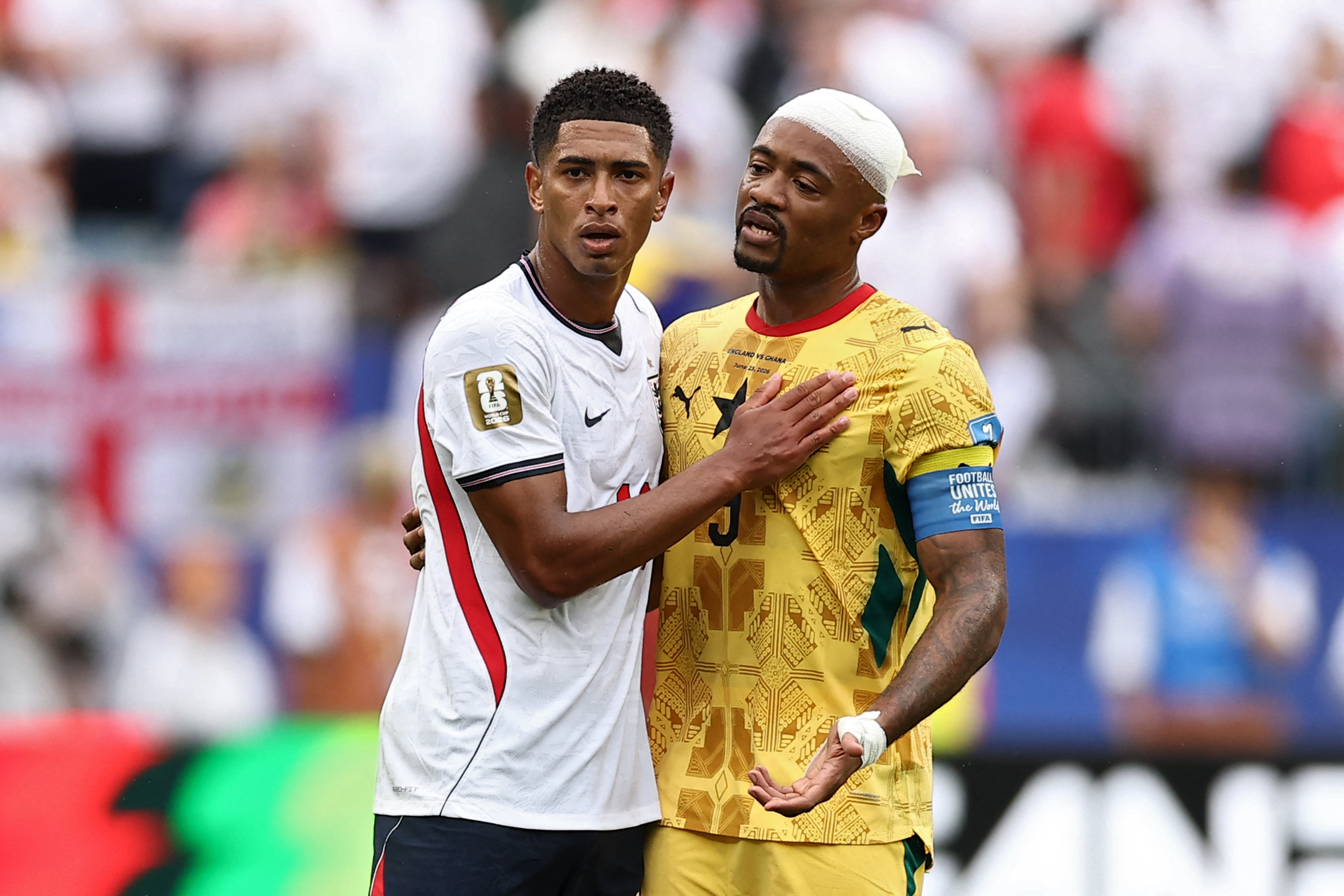 England's midfielder #10 Jude Bellingham (L) reacts with Ghana's forward #09 Jordan Ayew during the 2026 World Cup Group L football match between England and Ghana at the Boston Stadium in Foxborough on June 23, 2026. (Photo by CHARLY TRIBALLEAU / AFP)