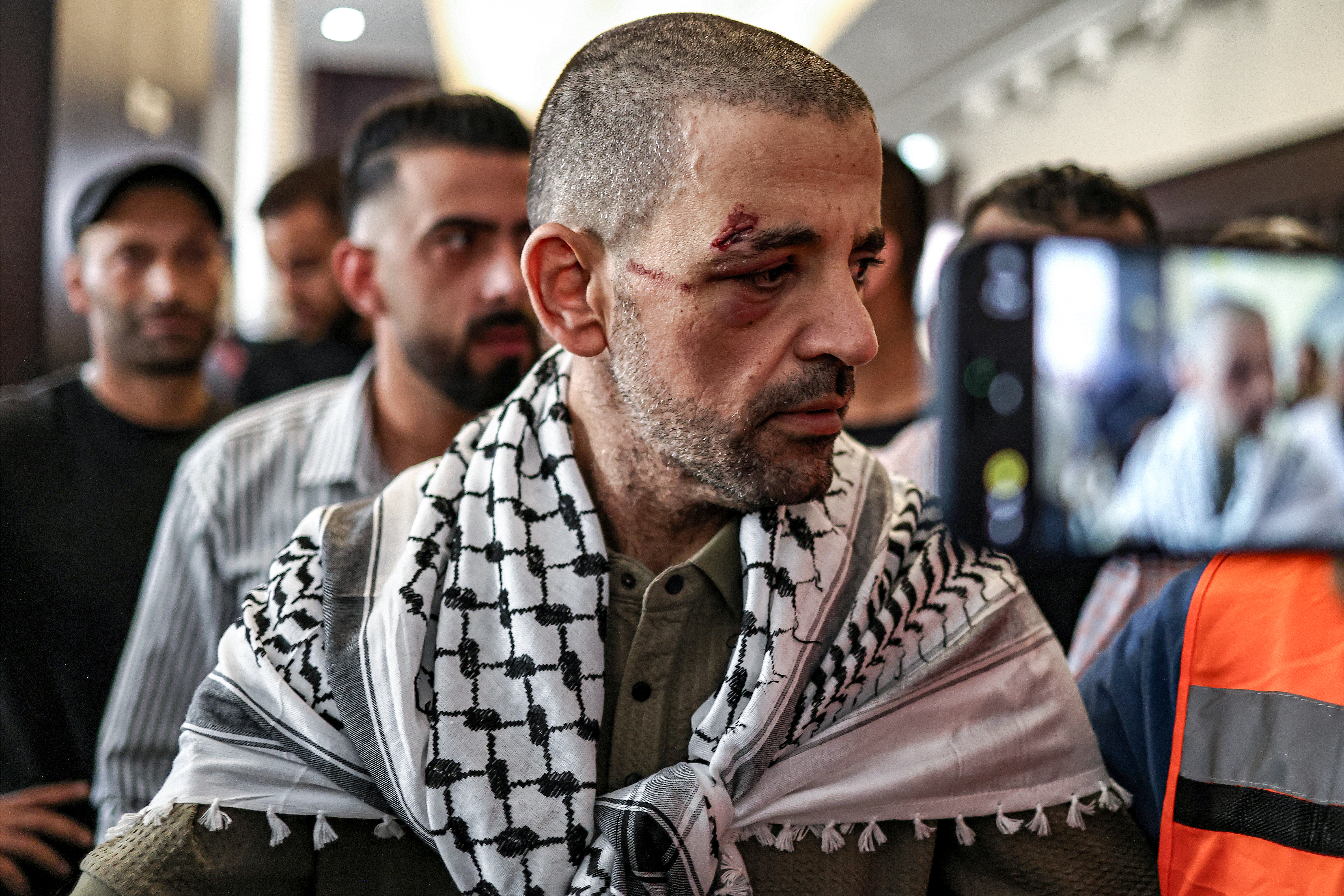 One of the Palestinian prisoners, who was released in a prisoner-hostage swap and ceasefire deal between Israel and Hamas, looks on upon arrival by bus at Ramallah Cultural Centre in Ramallah in the occupied West Bank, on October 13, 2025