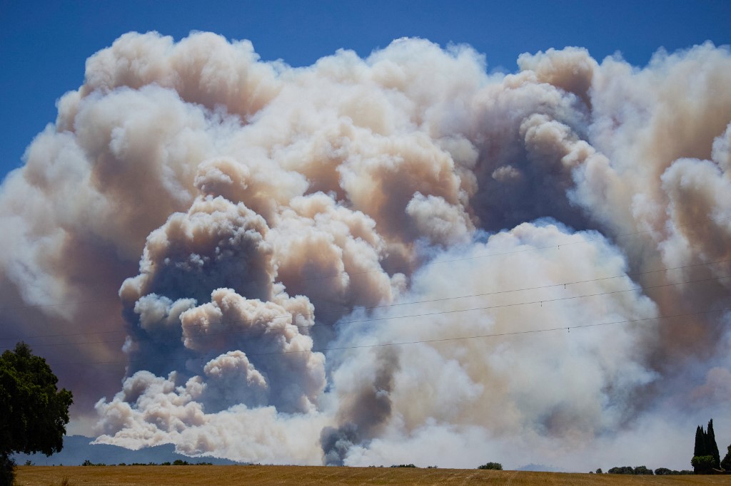 A photograph taken on July 3, 2026 shows smoke rising from a fire burning near La Bisbal de l’Emporda, northeastern Spain. (Photo by AFP)