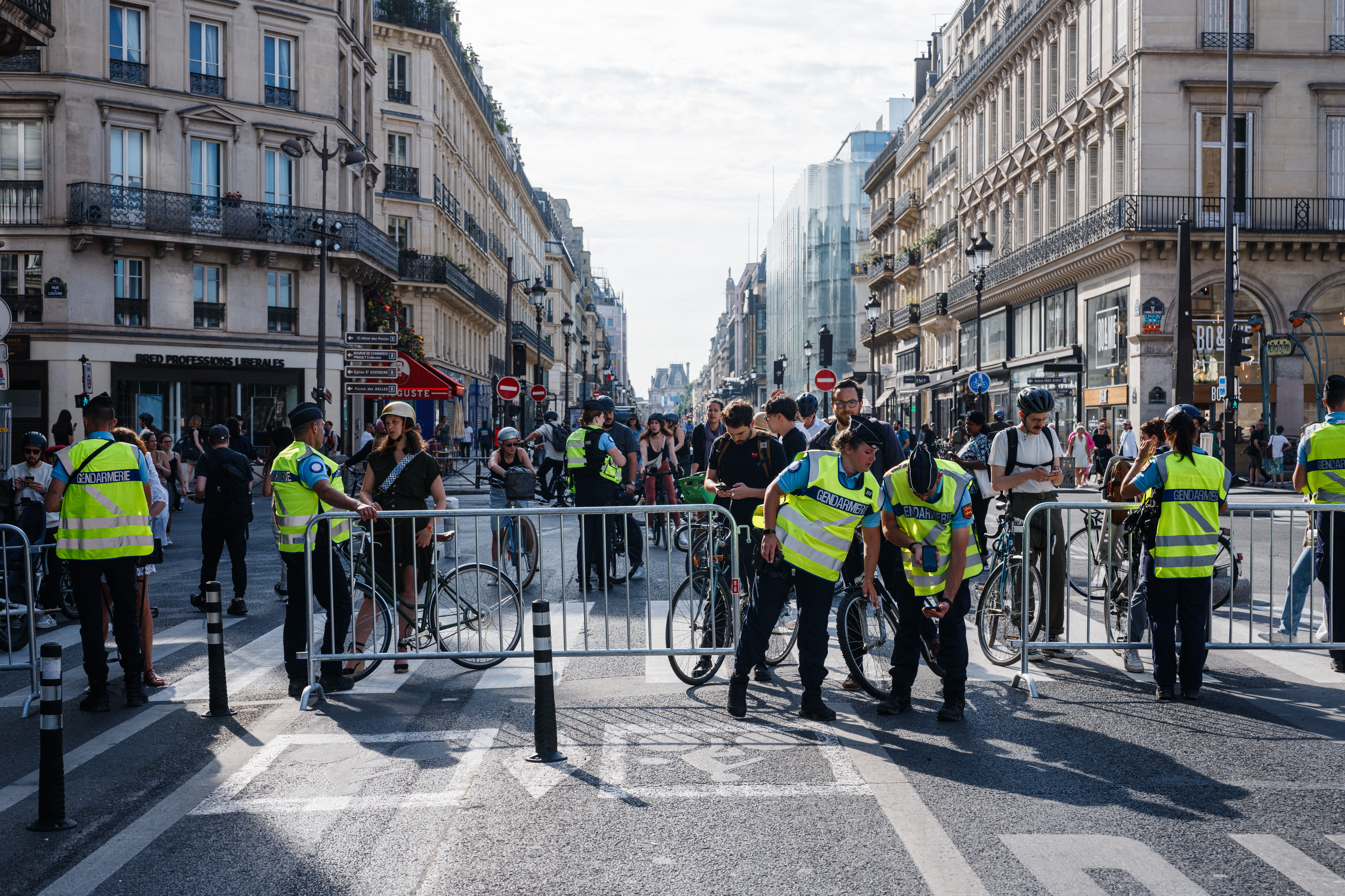 French Gendarmerie officers check pedestrians and cyclists QR codes. (Photo by Dimitar DILKOFF / AFP)