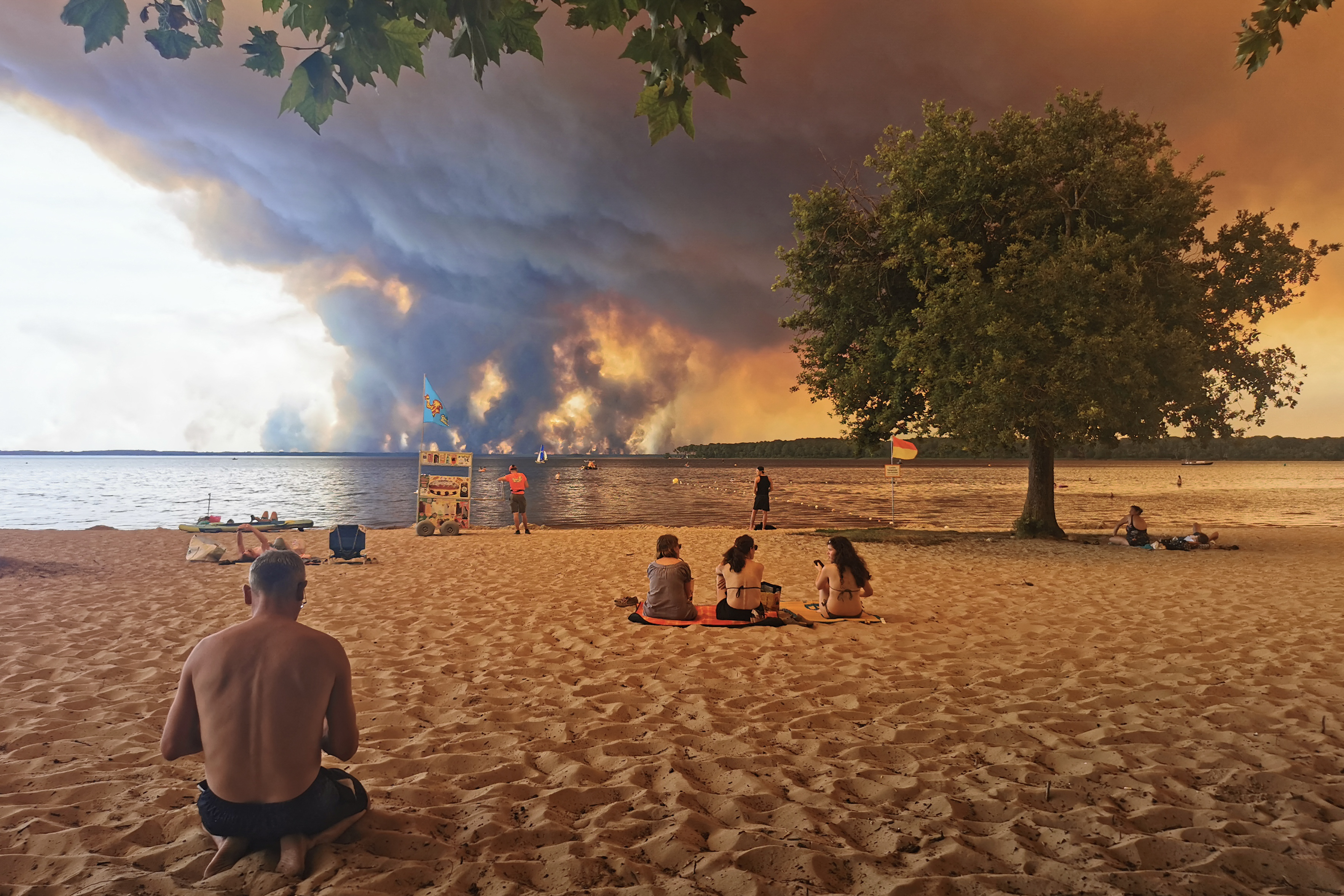 Beach goers rest on the beach of Moutchic on the shore of Lake Lacanau. (Photo by Maximilien LAMY / AFP)