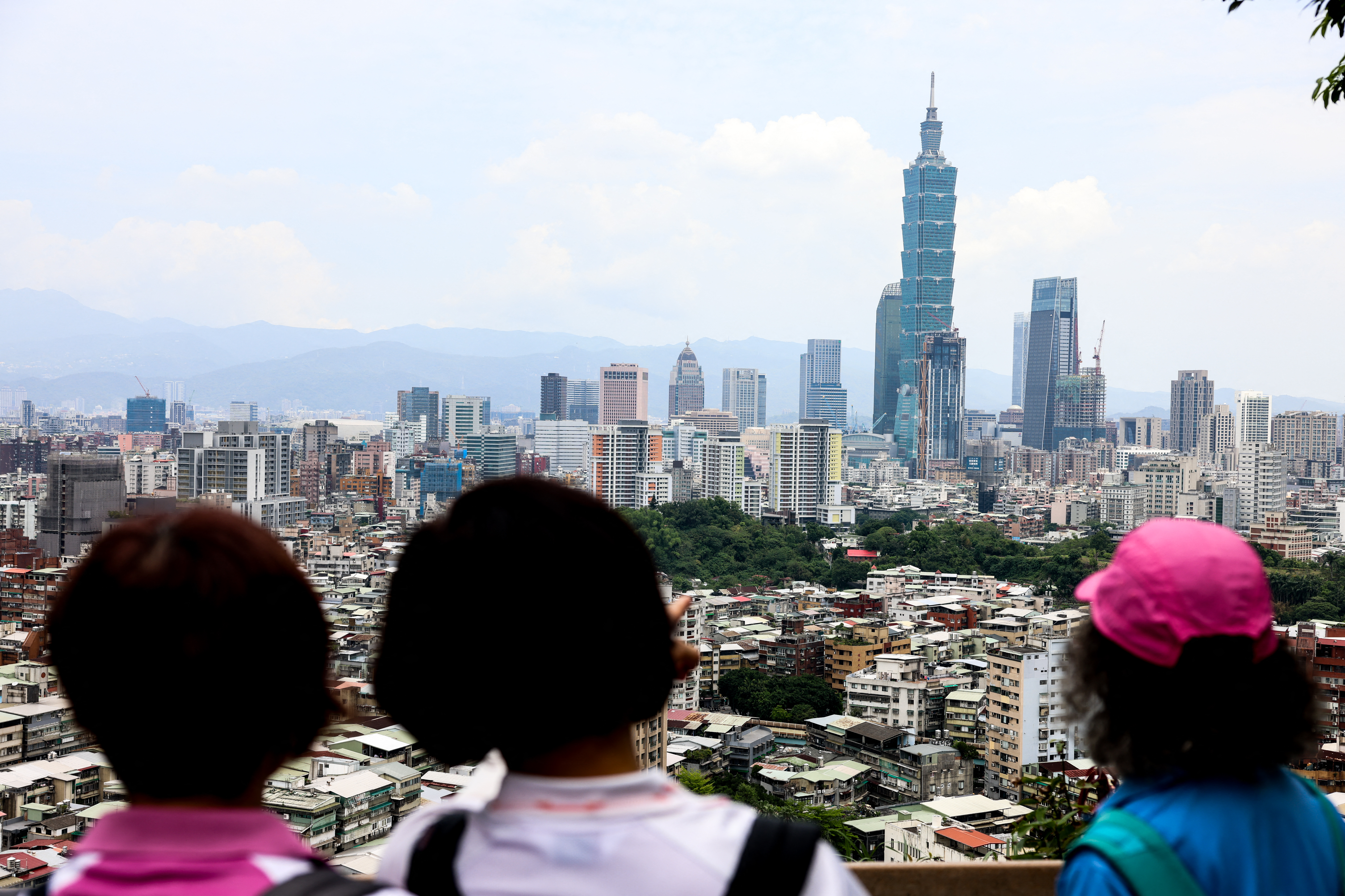 People look at the Taipei 101 building standing among residential and commercial buildings in Taipei on April 28, 2026 (Photo by I-Hwa Cheng / AFP)