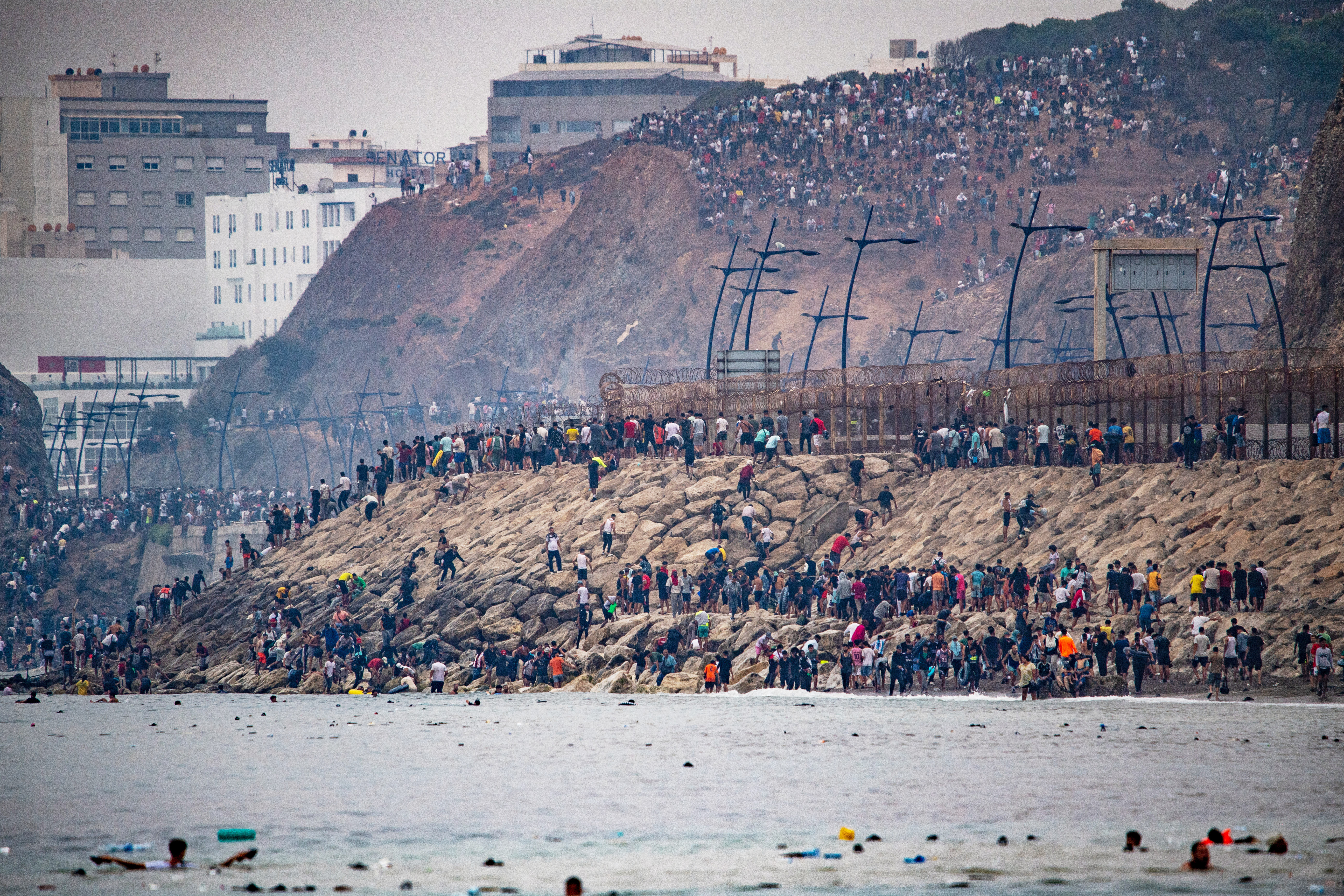 Migrants return to Morocco from the Spanish enclave of Ceuta, Friday, July 31, 2026. (AP Photo/Antonio Sempere)
