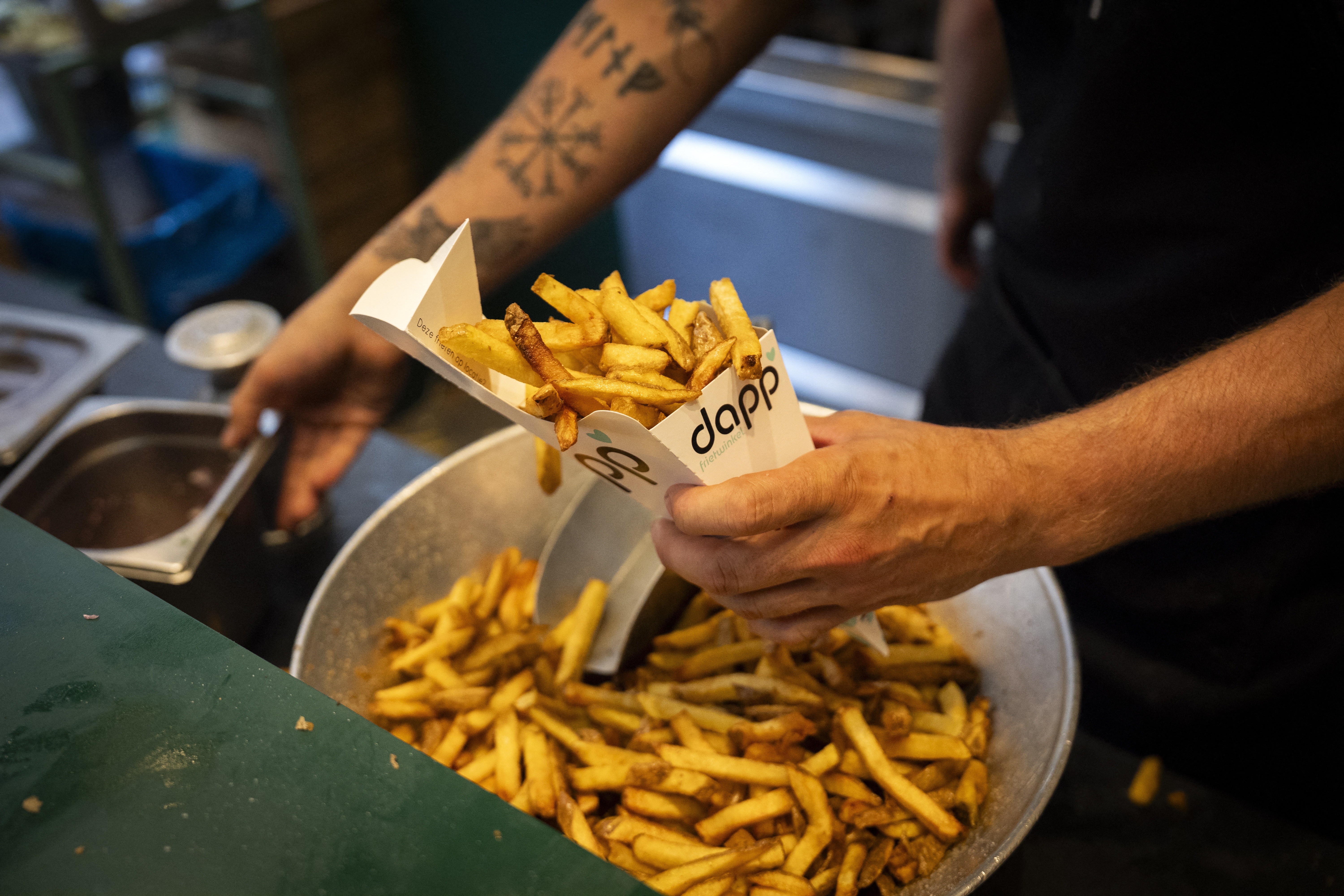 A member of staff fills a cone of chips at the Dapp Frietwinkel restaurant, in Utrecht, on September 28, 2025