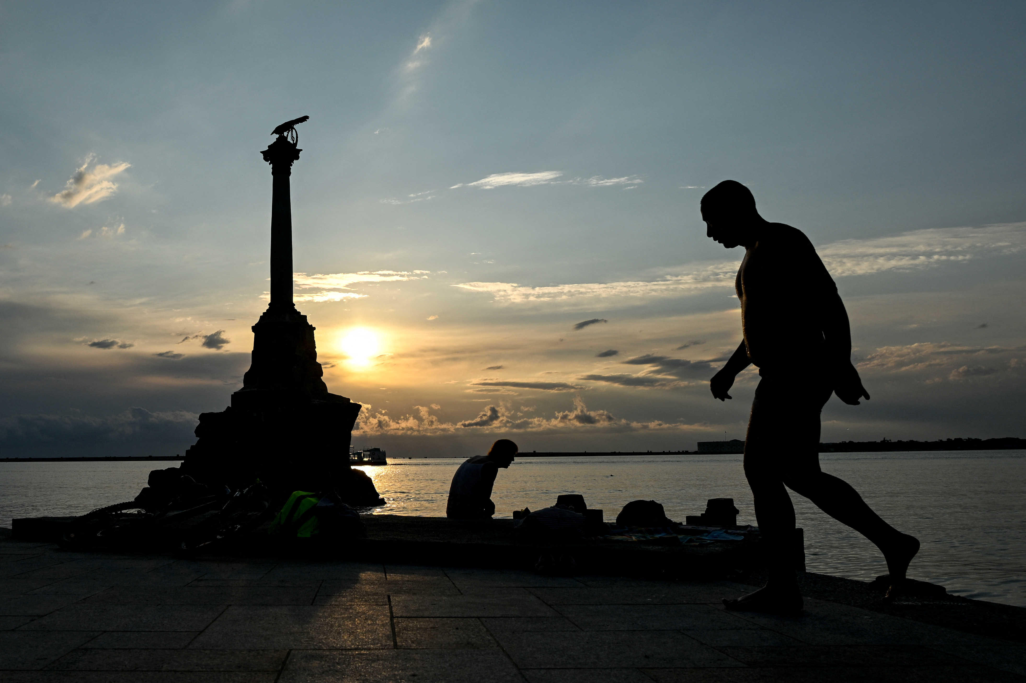 A man walks past the Monument of The Sunken Ships in central Sevastopol, on the Russian-annexed peninsula of Crimea, on July 22, 2026.