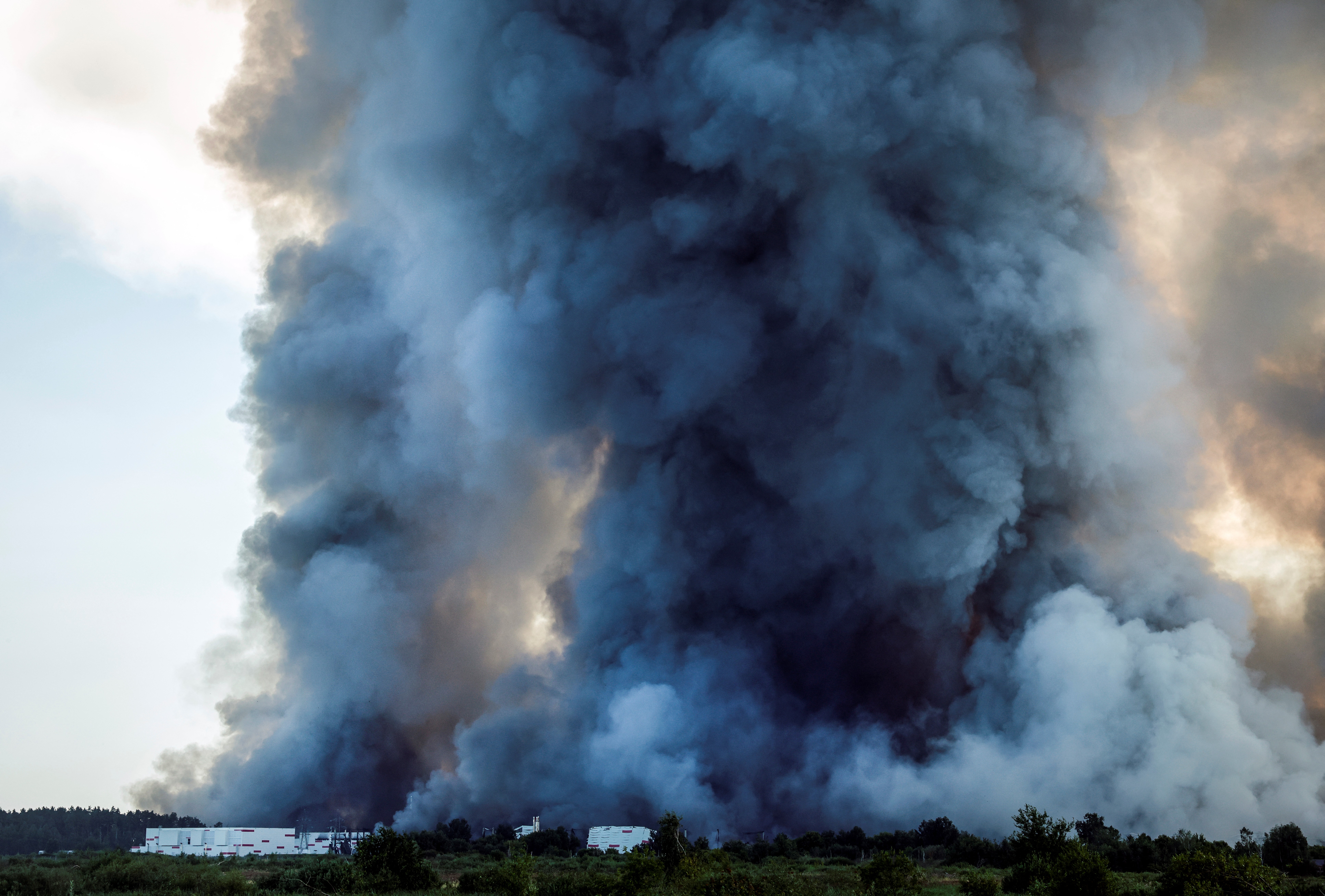 Smoke of a fire at the Russian e-commerce firm Wildberries' logistics complexes. (Photo by TATYANA MAKEYEVA / AFP)