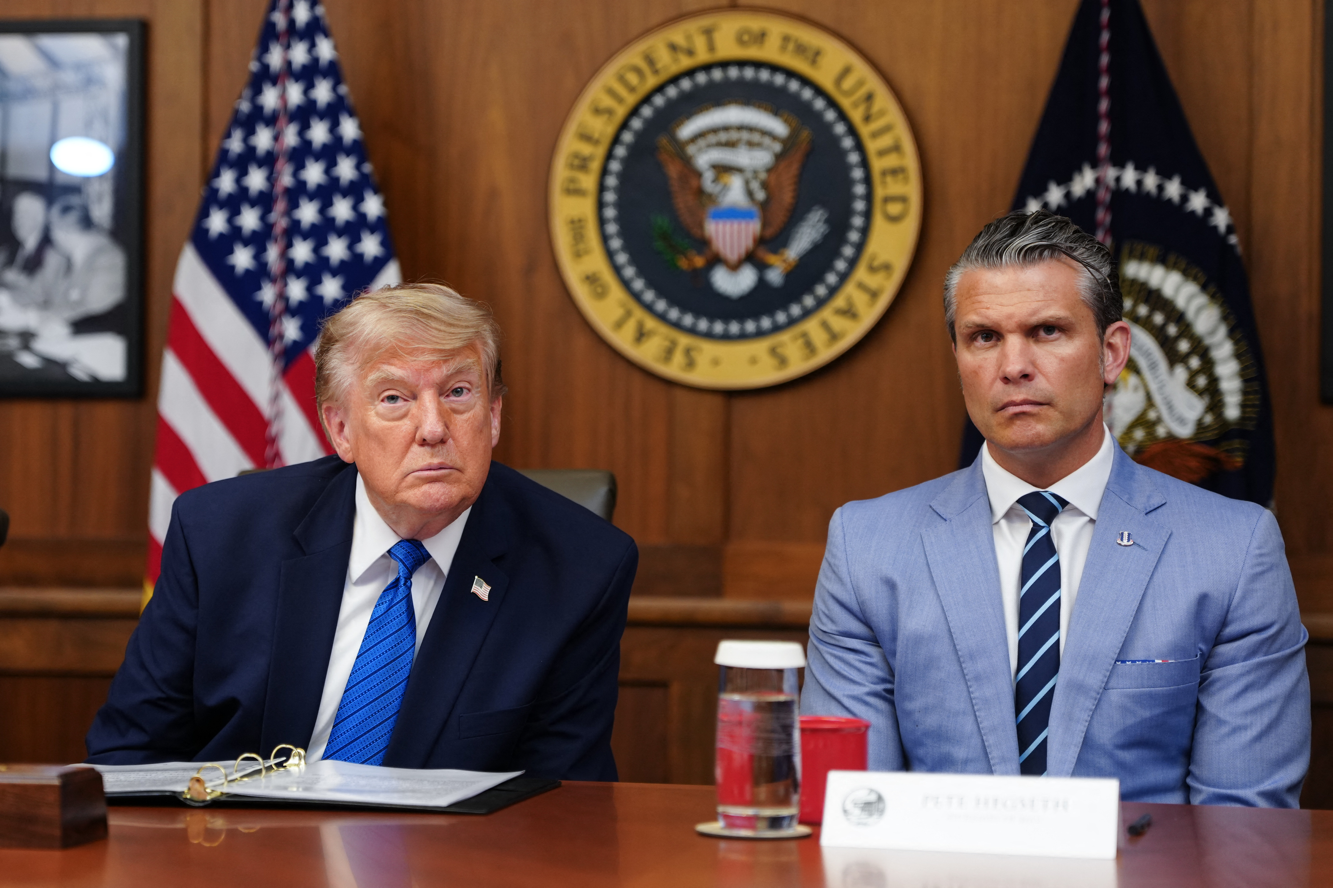 US President Donald Trump and US Secretary of Defense Pete Hegseth listen to questions from the press during a Cabinet meeting at Camp David in Maryland