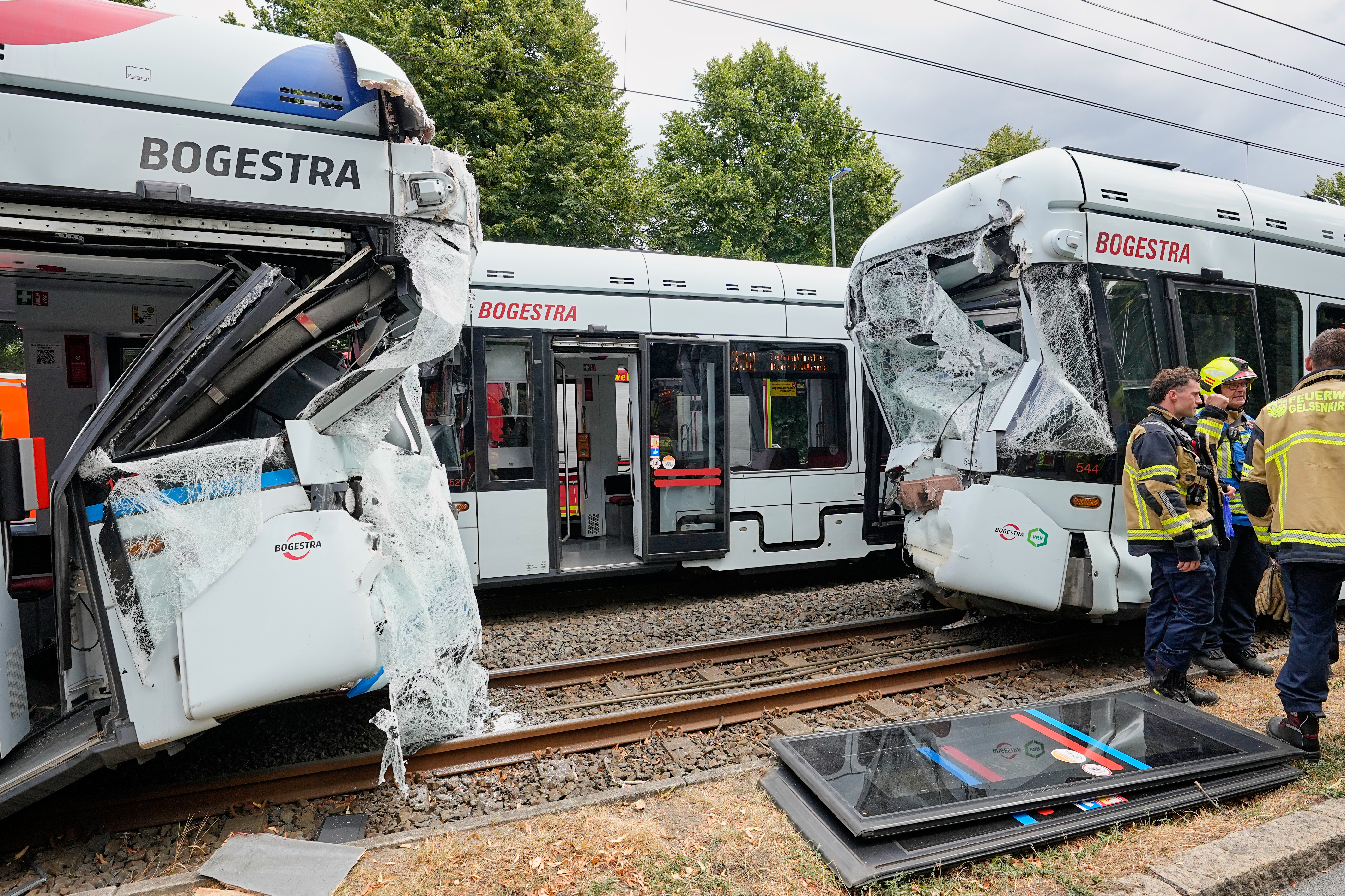 Emergency responders work at the scene of an accident where two trams collided in Gelsenkirchen, Germany, Thursday, Aug. 6, 2026. (AP Photo/Martin Meissner)