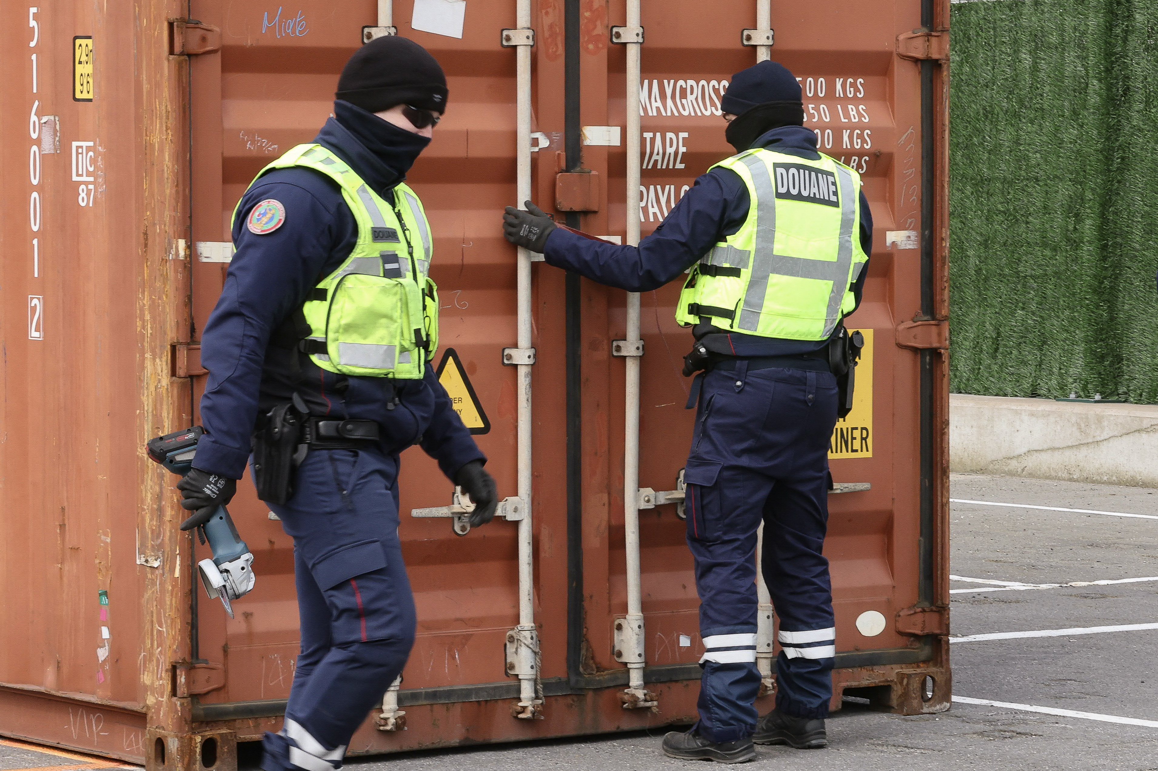 Customs officers inspect a shipping container at the port of Dunkirk. (Photo by Francois LO PRESTI / AFP)