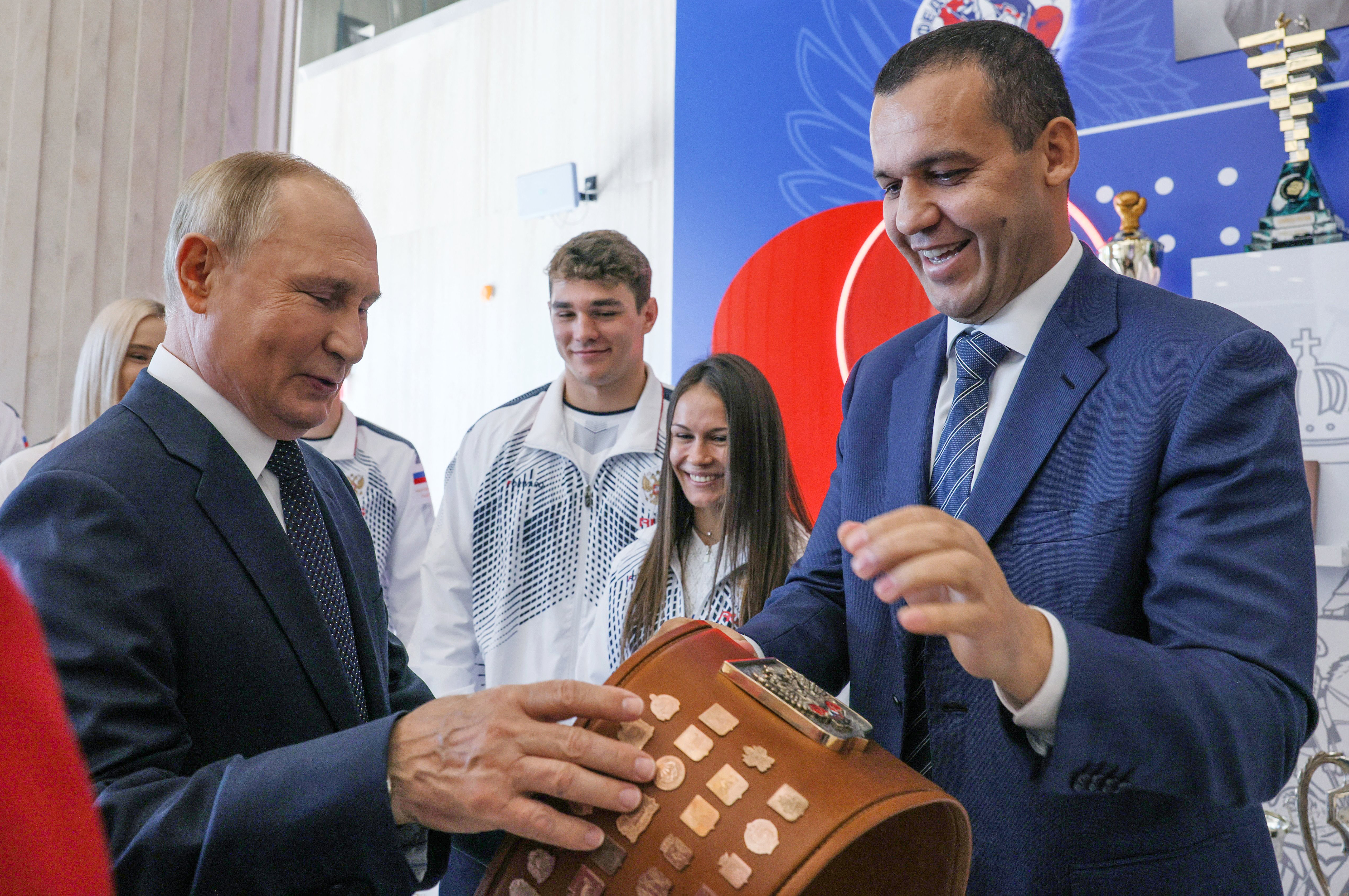 Russia's President Vladimir Putin (L) and International Boxing Assosiation (AIBA) President Umar Kremlev (R) tour the newly opened International Boxing centre at the Luzhniki Sports Complex