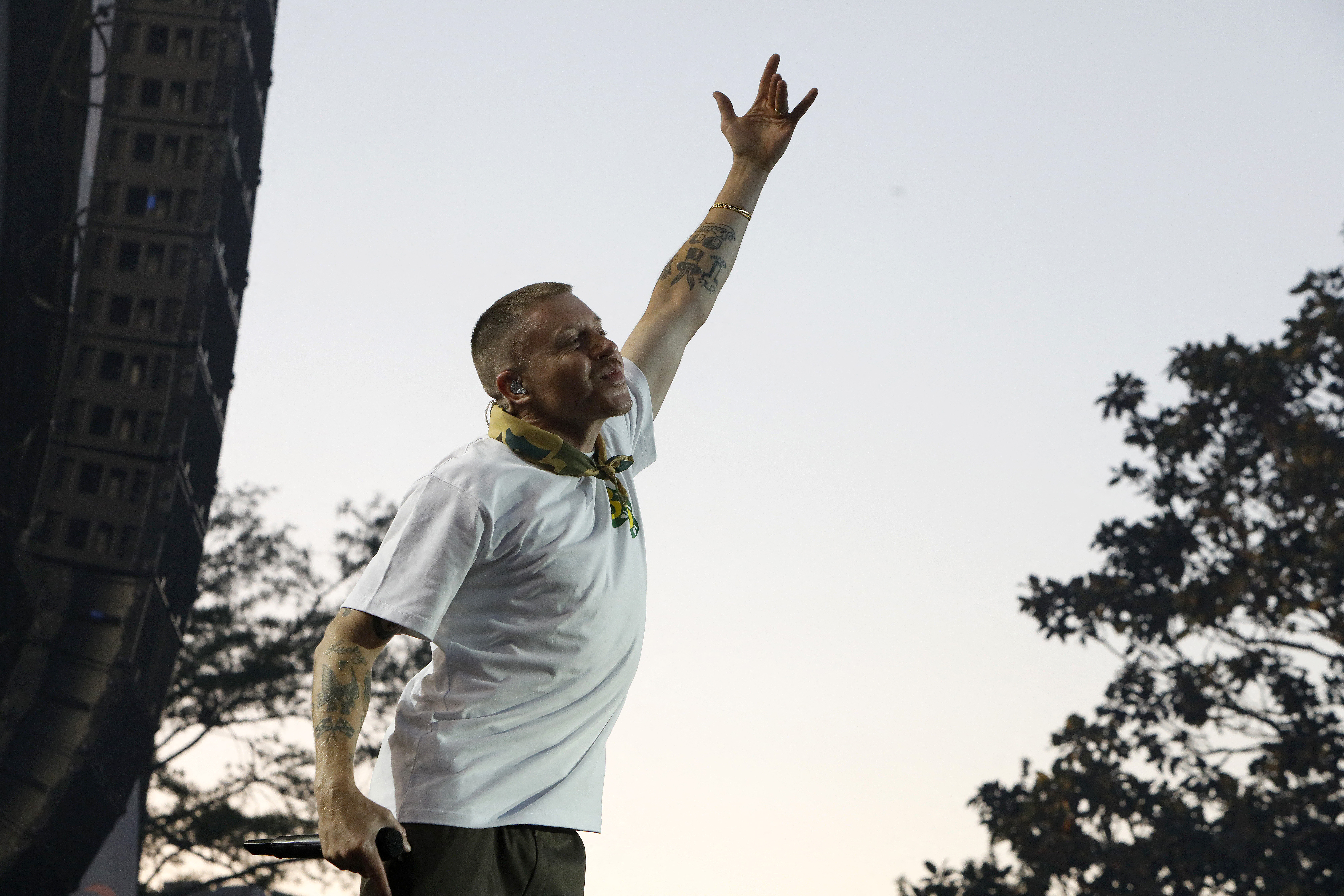 NEW ORLEANS, LOUISIANA - APRIL 03: Mackelmore performs on stage during the 2022 NCAA March Madness Music Festival at Woldenberg Park on April 03, 2022 in New Orleans, Louisiana