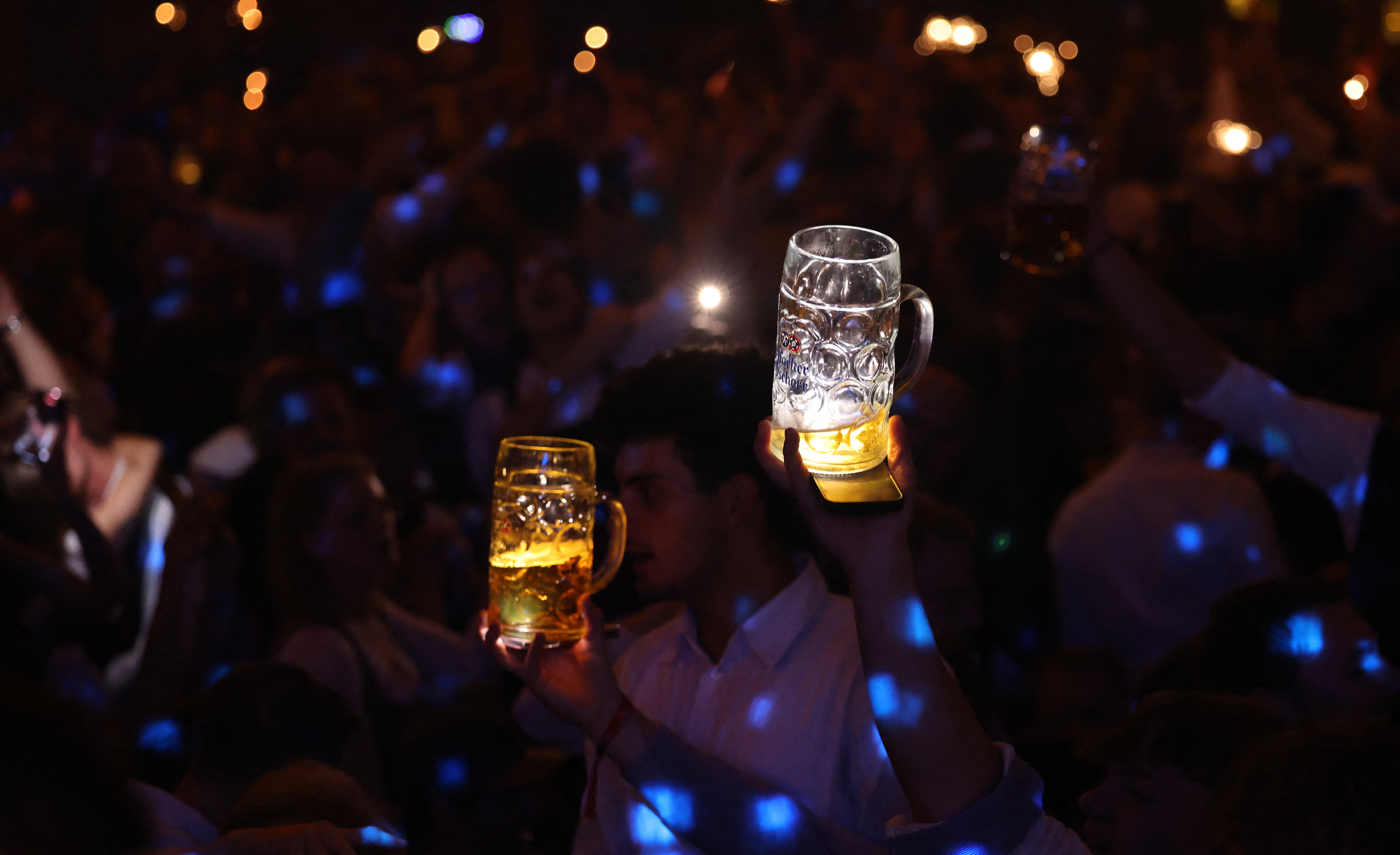 Waitresses at the Hofbrau tent dance on the beer tables on the last day of the world's largest beer festival, Oktoberfest, on October 5, 2025 in Munich, (Photo by ALEXANDRA BEIER / AFP)