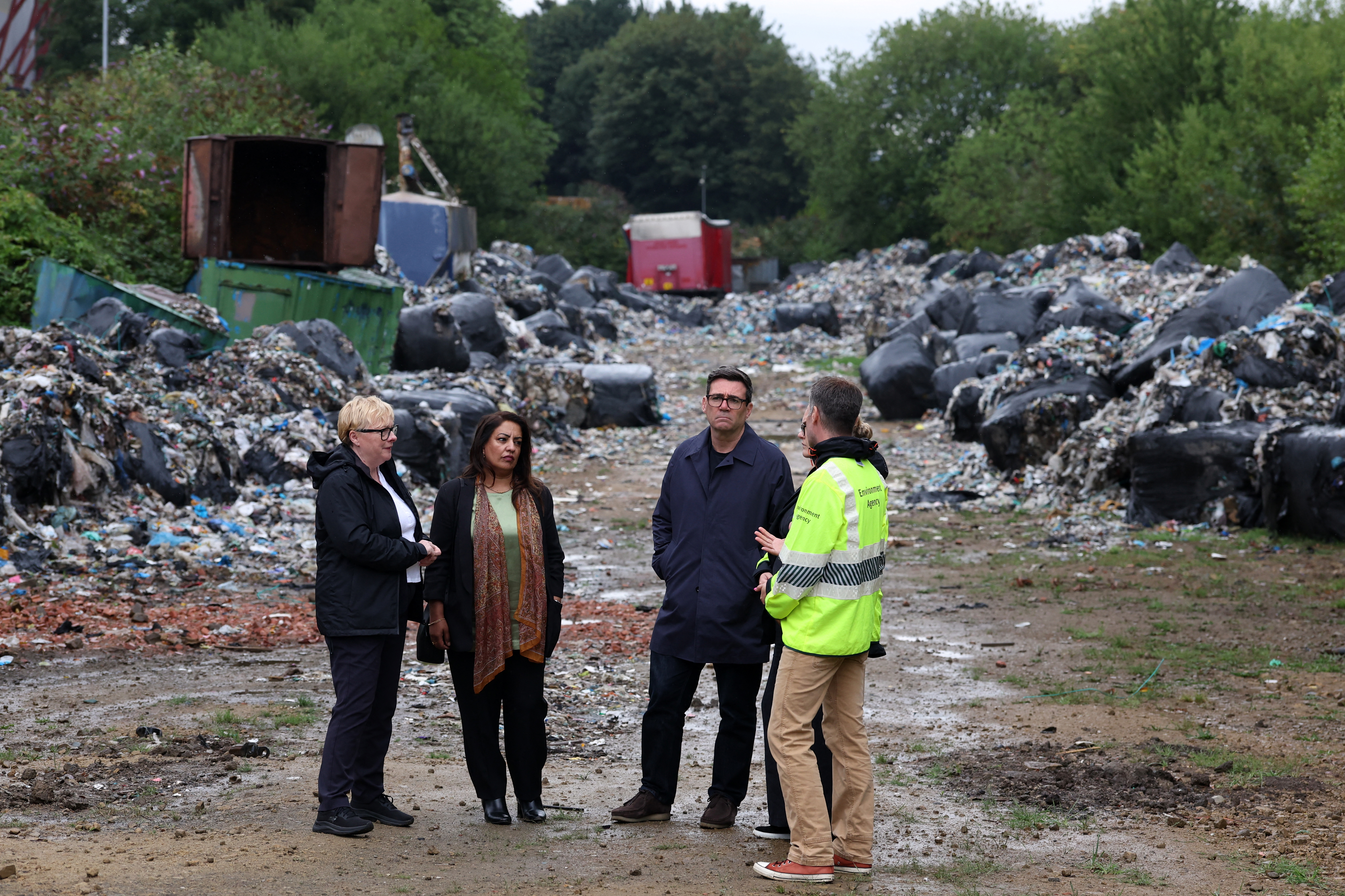 Labour MP for Bradford West Naz Shar (2L), and Environment agency staff show Britain's Prime Minister Andy Burnham (C) and Britain's Secretary of State for Environment, Food and Rural Affairs Angela Eagle (L)