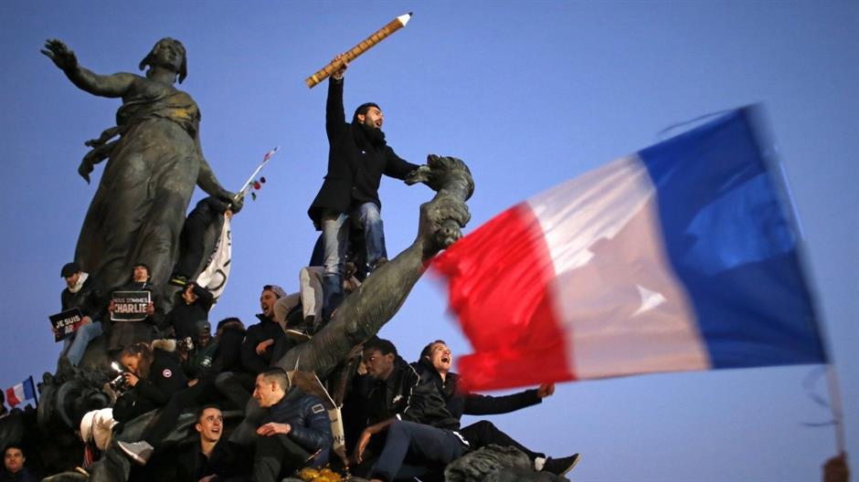 a-man-holds-a-giant-pencil-as-he-takes-part-in-a-solidarity-march-in-paris-on-january-11-2015-the-march-follows-the-horrific-attacks-by-45583.jpeg