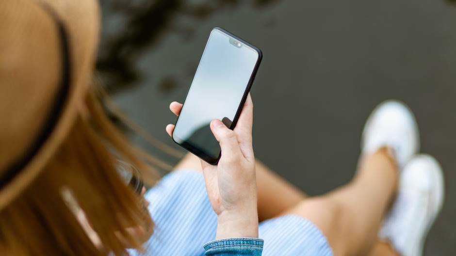 person-holding-smartphone-white-sitting-1310532