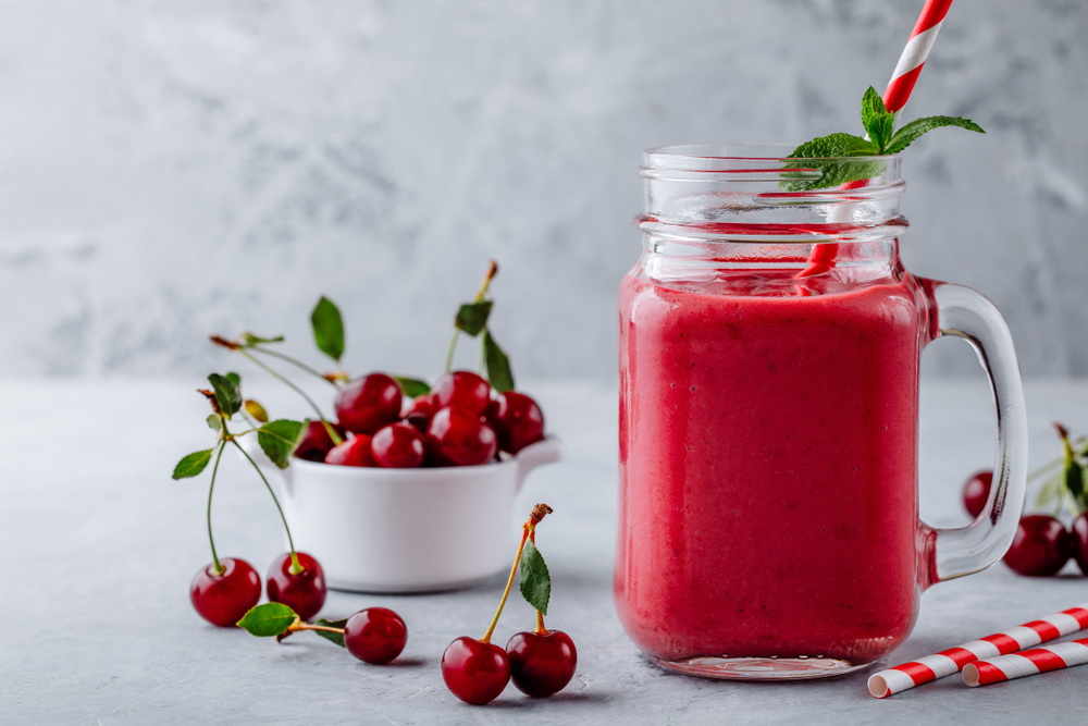 Cherries,And,Banana,Smoothie,In,Glass,Mason,Jar,With,Straw