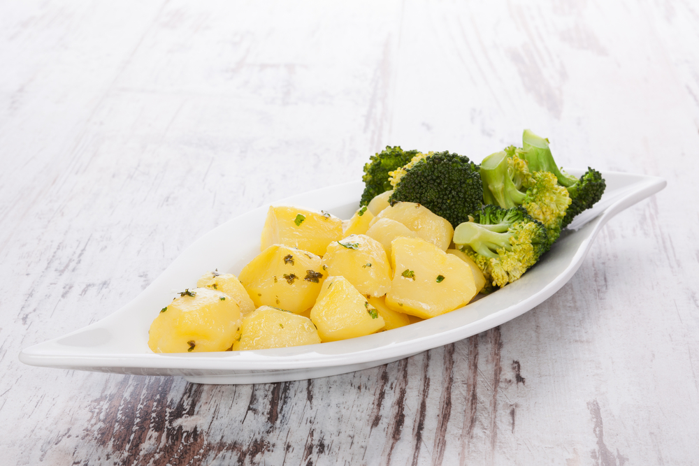 Steamed,Vegetables,Potatoes,And,Broccoli,On,White,Plate,On,Wooden