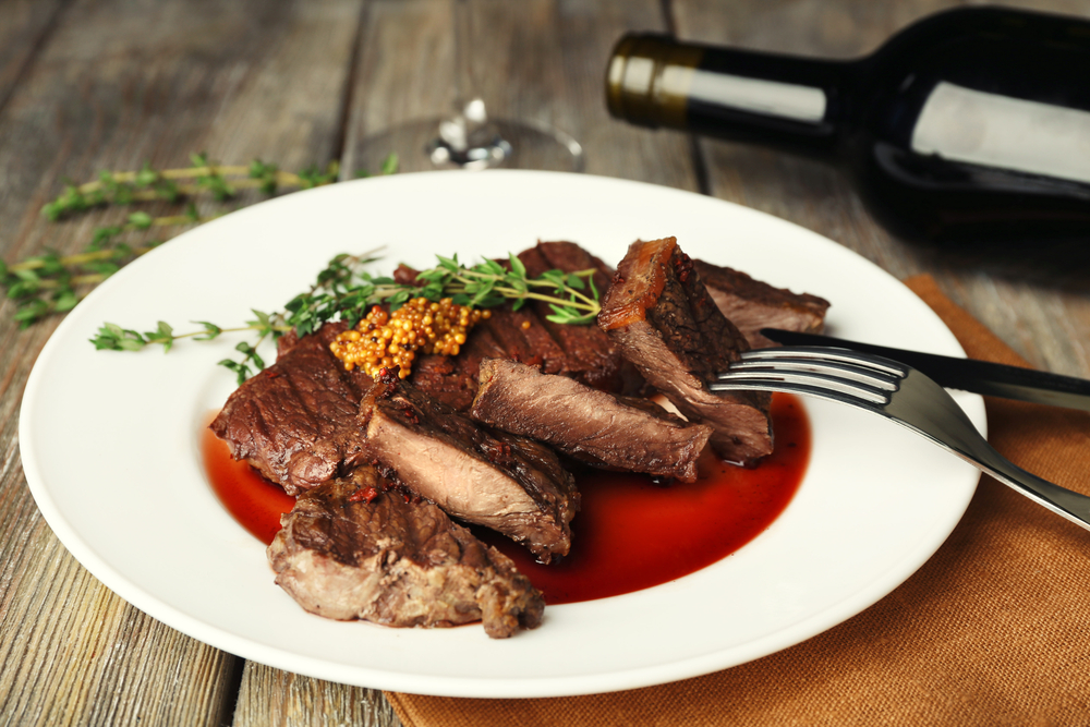 Steak,On,Plate,With,Bottle,Of,Wine,On,Wooden,Background