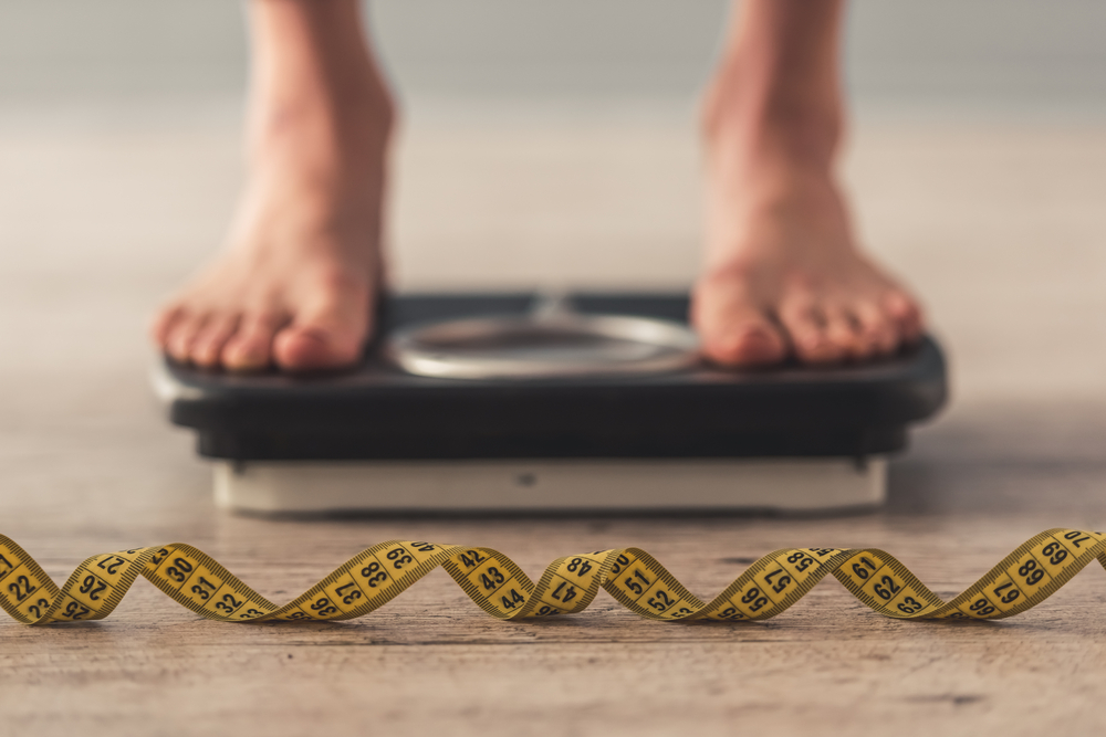 Cropped,Image,Of,Woman,Feet,Standing,On,Weigh,Scales,,On